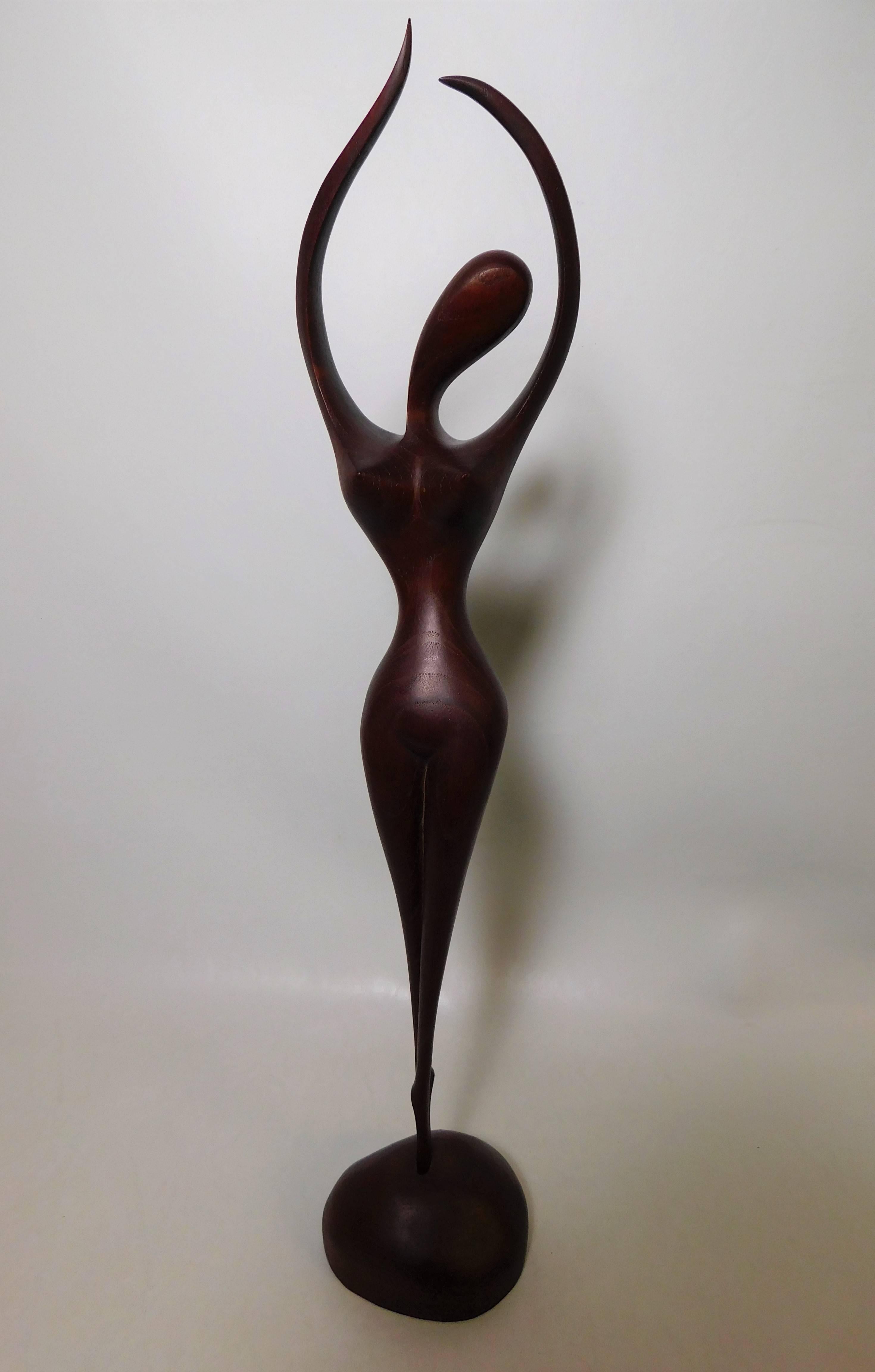 This Mid-Century Modern Danish teak figurative sculpture is signed but the artist is unknown. It was imported to Canada by the Denmark furniture company Toronto.