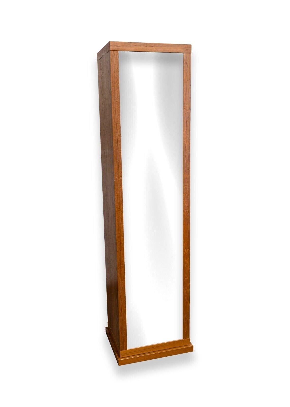 A Danish teak wood rotating bookshelf with full body mirror. A gorgeous piece of Danish furniture. This piece features a unique rotating design with 4 shelves and a center pull out drawer on one side, and a full length body mirror on the other. This