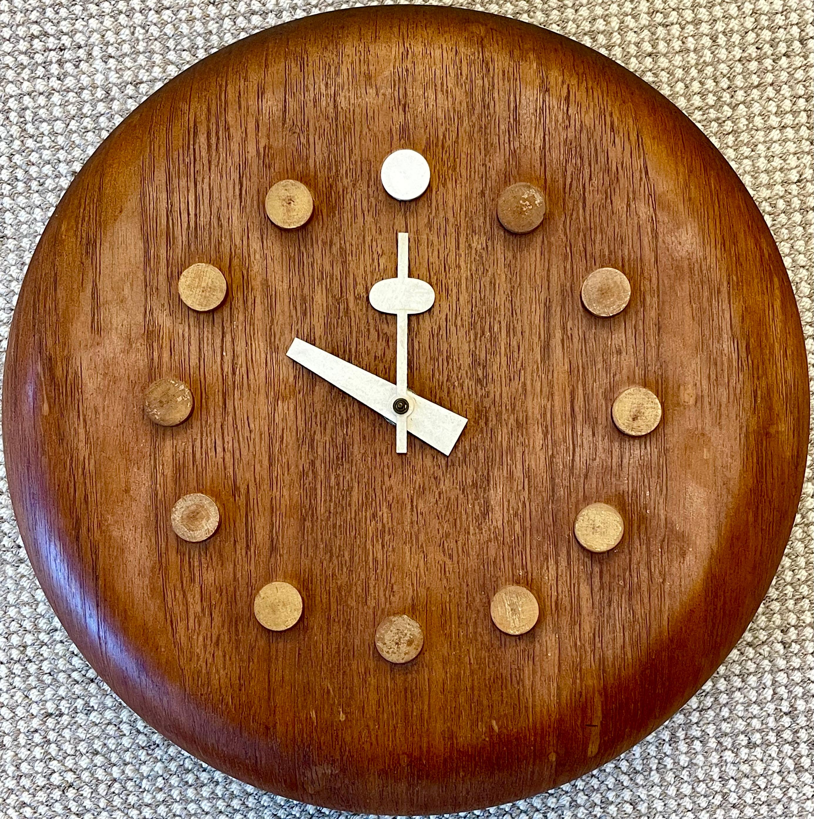 Stool seat wall clock, model 7512, c. 1957 by Fritz Hansen. This finely decorative wall clock is simply stunning and is certain to draw conversation in any room in the home. 
Produced by George Nelson & Associates, USA, 1950s Stamped 'FH DENMARK'