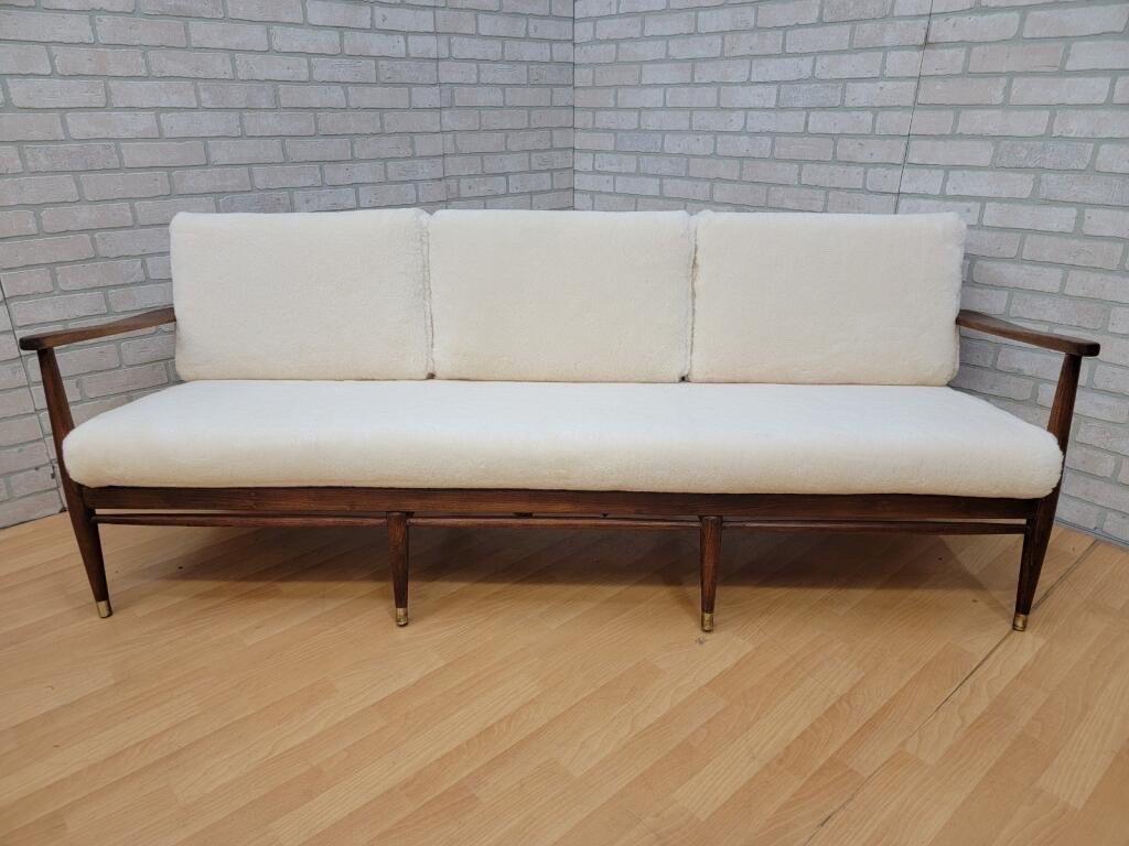 Mid-Century Modern Danish Walnut frame sofa by Ib Kofod-Larsen Newly Upholstered in a High End Ivory Sheep's Wool Shearling 

Elegant Danish modern sofa designed by architect and furniture designer Ib Kofod Larsen for Selig in Denmark. This iconic