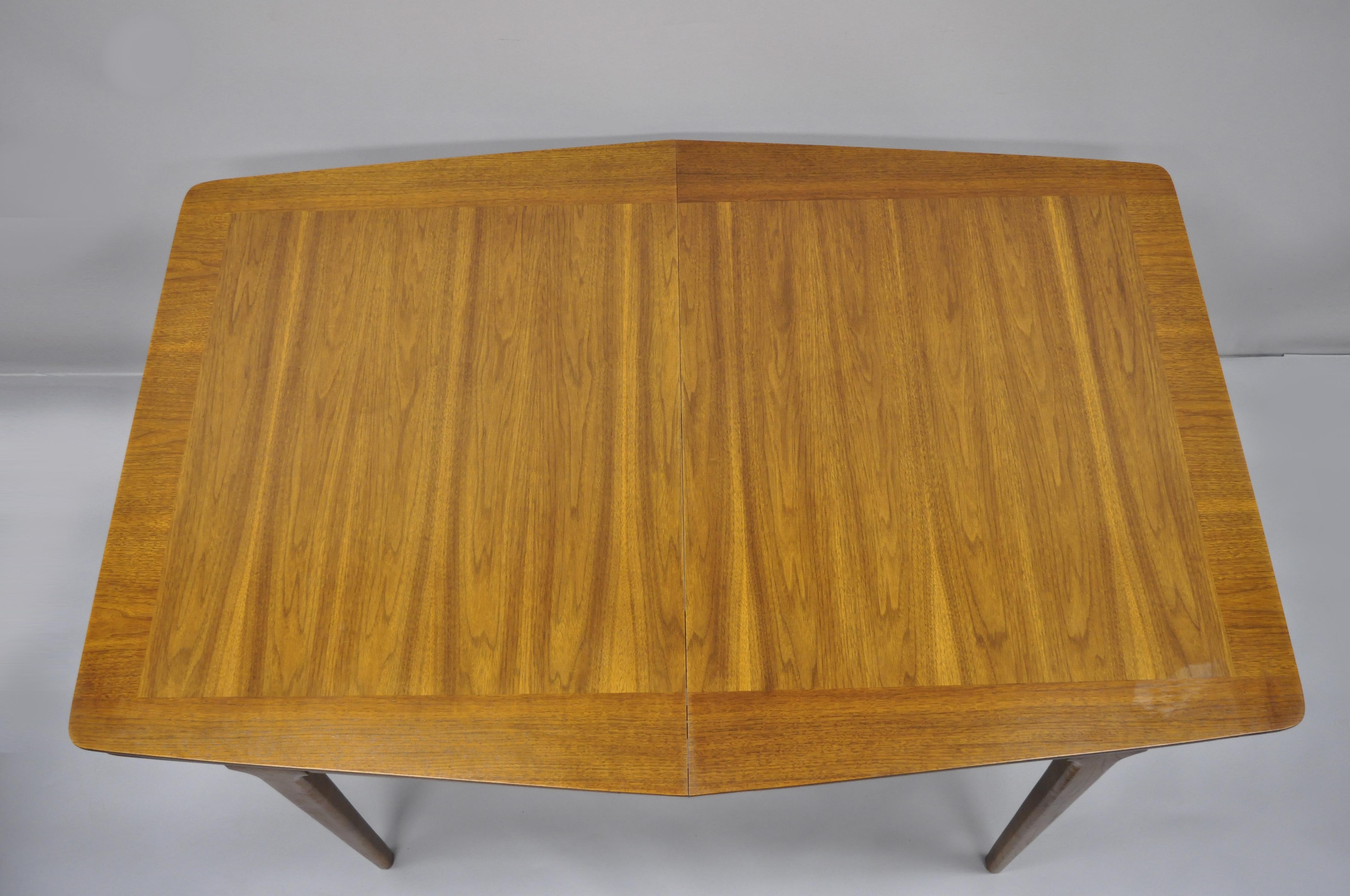 Mid-Century Modern Danish walnut sculpted edge dining table with 1 leaf. Item features (1) 12
