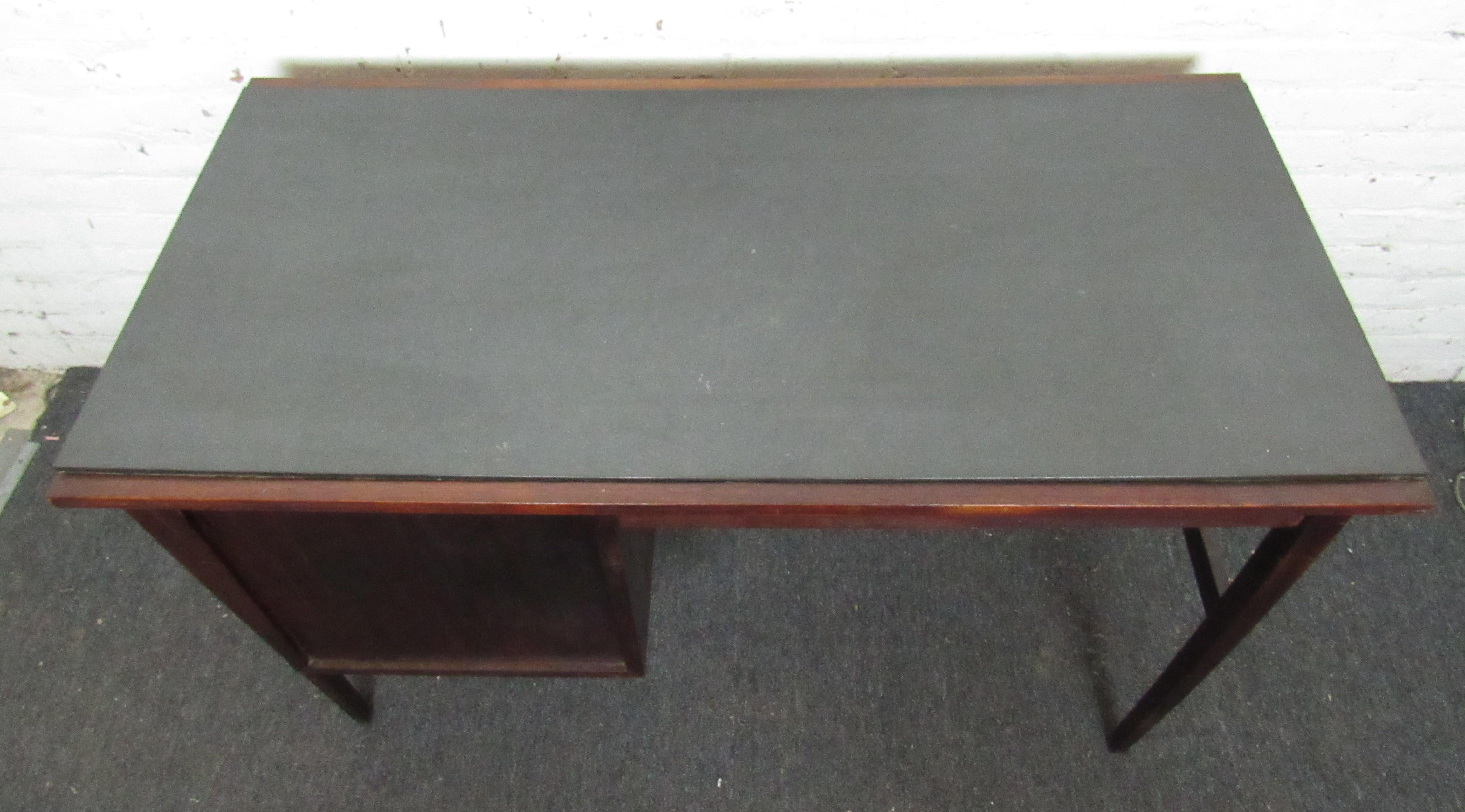 Beautiful vintage modern Danish Writing desk with a unique slate top. The desk features one smaller drawer and one file sized drawer. The drawers have beautiful sculpted wood handles.

(Please confirm item location - NY or NJ - with dealer).