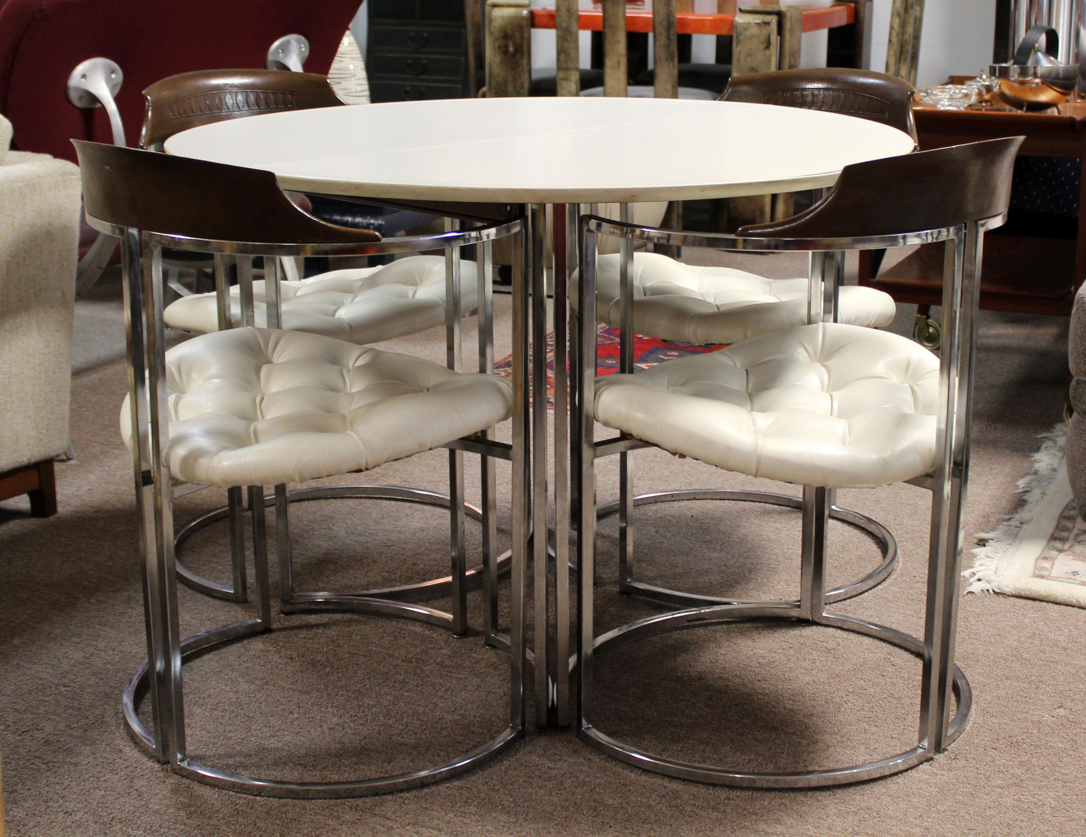 For your consideration is a magnificent dinette set, including a table made of chrome and with a white laminate top, with one leaf, and four chairs made of chrome, wood and white leather, by Daystrom, circa the 1970s. In very good condition.