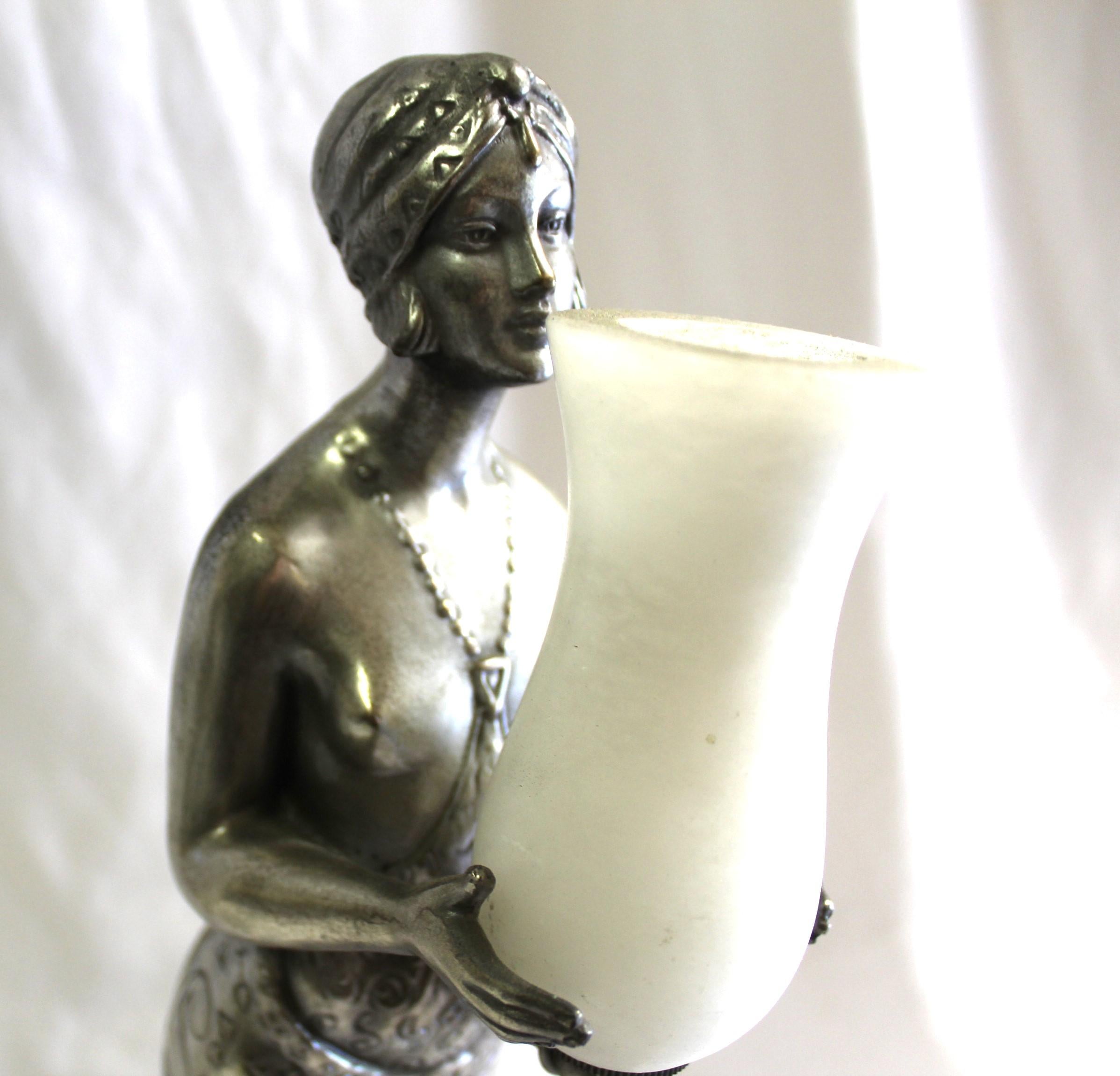 A well made Sculpture of a Young Lady holding an Alabaster Shade . Cast in lost wax bronze with an Antique Silver patina finish .  Standing mounted on a solid Black marble base . A nice deco looking lamp . Total ht is at 18