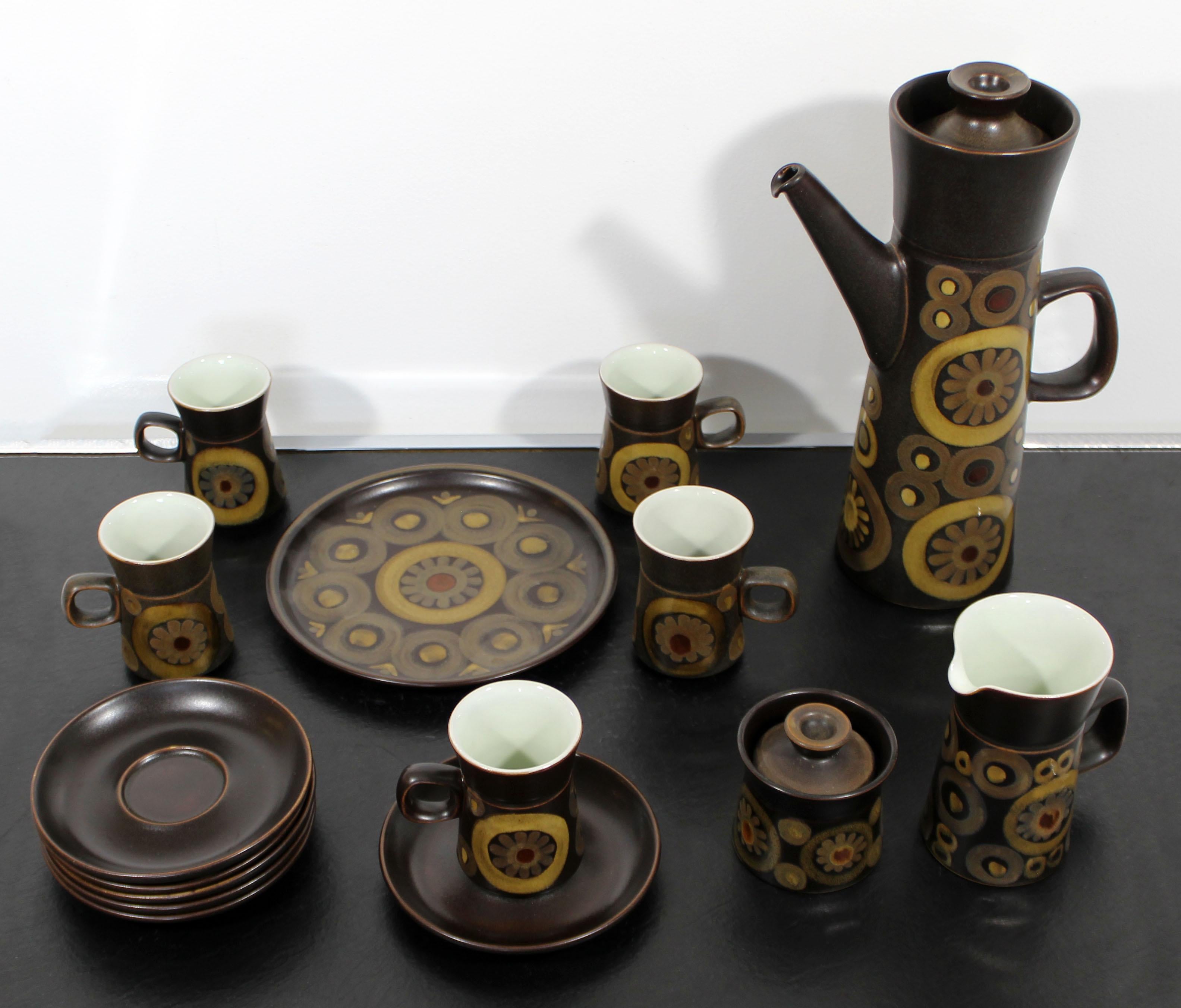 For your consideration is a Denby, Arabesque, floral pattern ceramic tea and coffee service set, made in England, circa 1960s. Set includes five mugs, six mug plates, a large plate, a sugar bowl, a creamer and a caraf. In excellent condition. The