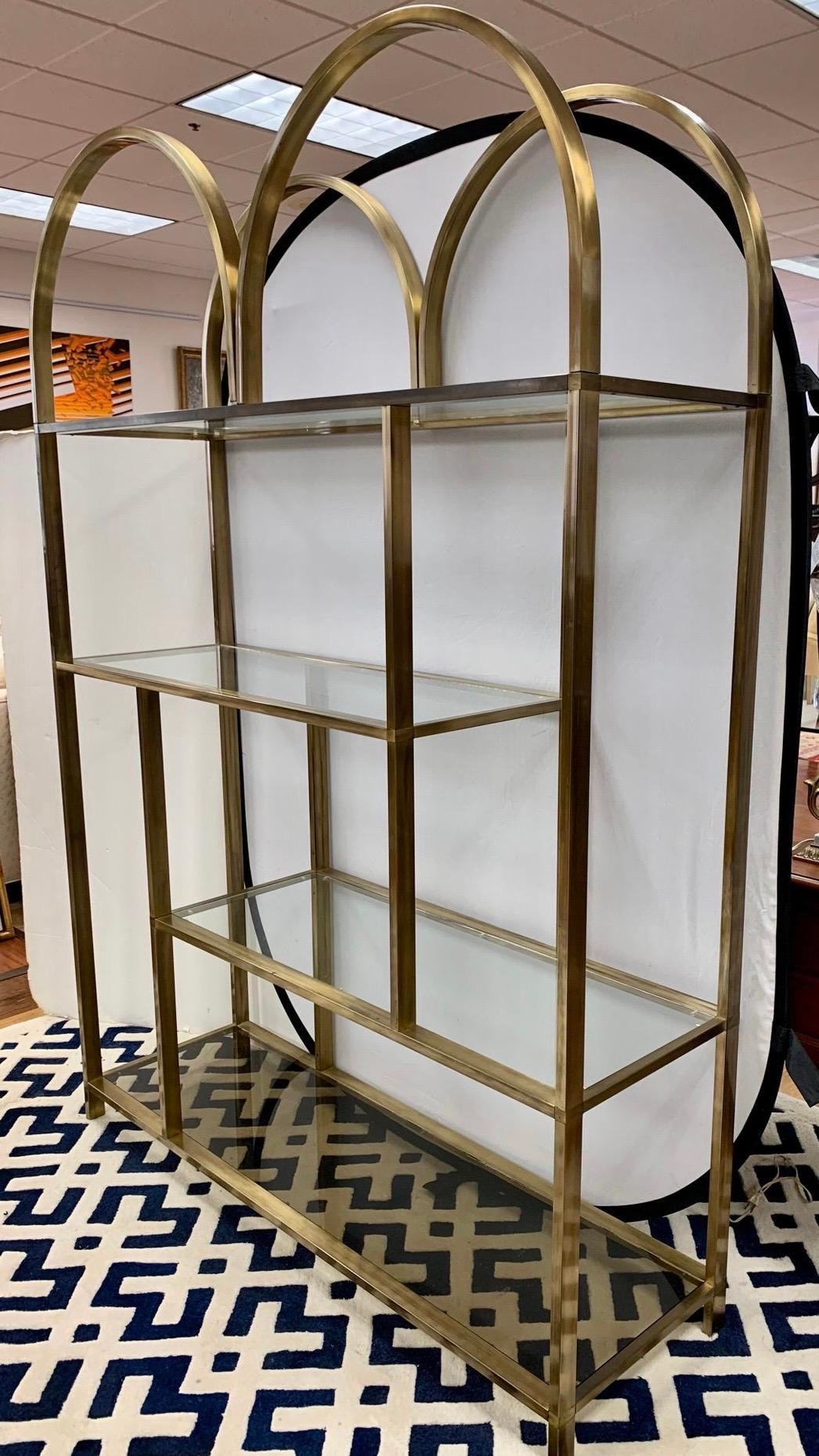 Iconic, Mid-Century Modern four shelf large etagere by DIA (Design Institute of America). Each piece of glass fits perfectly. Unlike most mid-century etageres, this one feautures a sculptural shape epitomized by the arched top. Quite gorgeous. Own