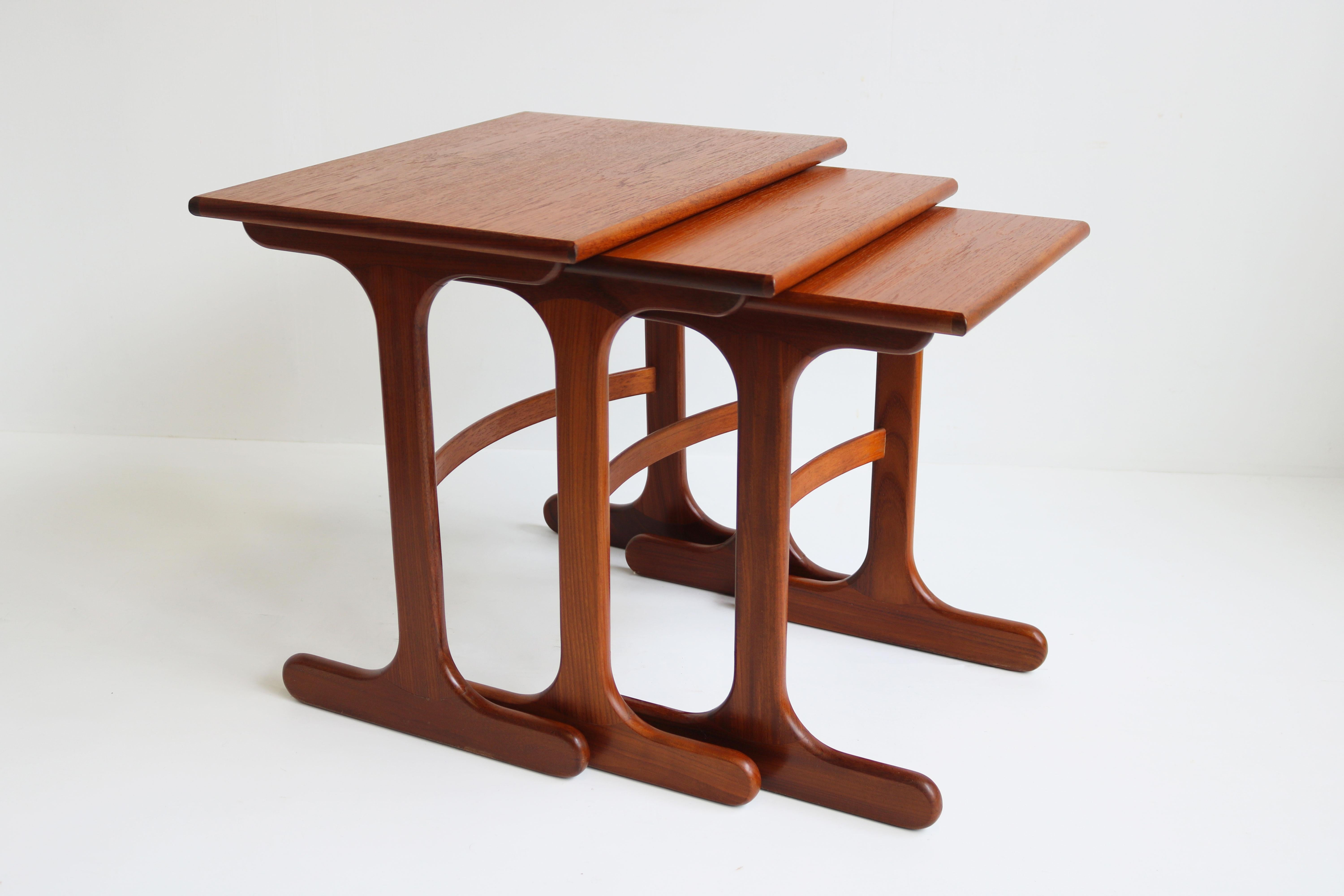 Gorgeous set of Mid-Century Modern design nesting tables in teak by G-Plan 1960. 
The 3 tables slide underneath each other allowing them to be taken out when needed swiftly. Very Practical 
Wonderfull organic design in solid teak & teak veneer.