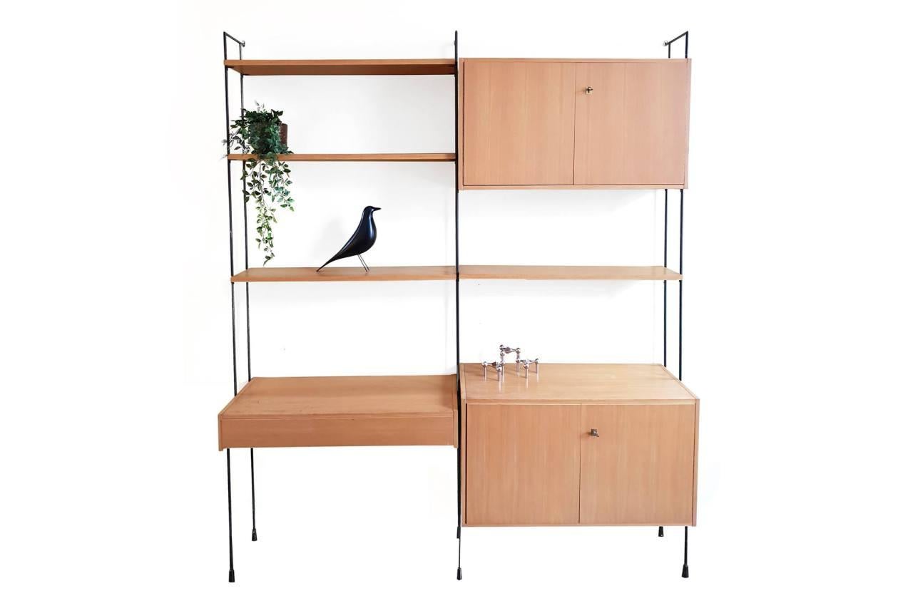 Beautiful modular Omnia wall system designed by Ernst Hilker from the 1960s, Germany. This wall system is very minimalistic and has a sleek design, which makes it a timeless piece of furniture in our eyes. Use this cabinet to work on, or to store