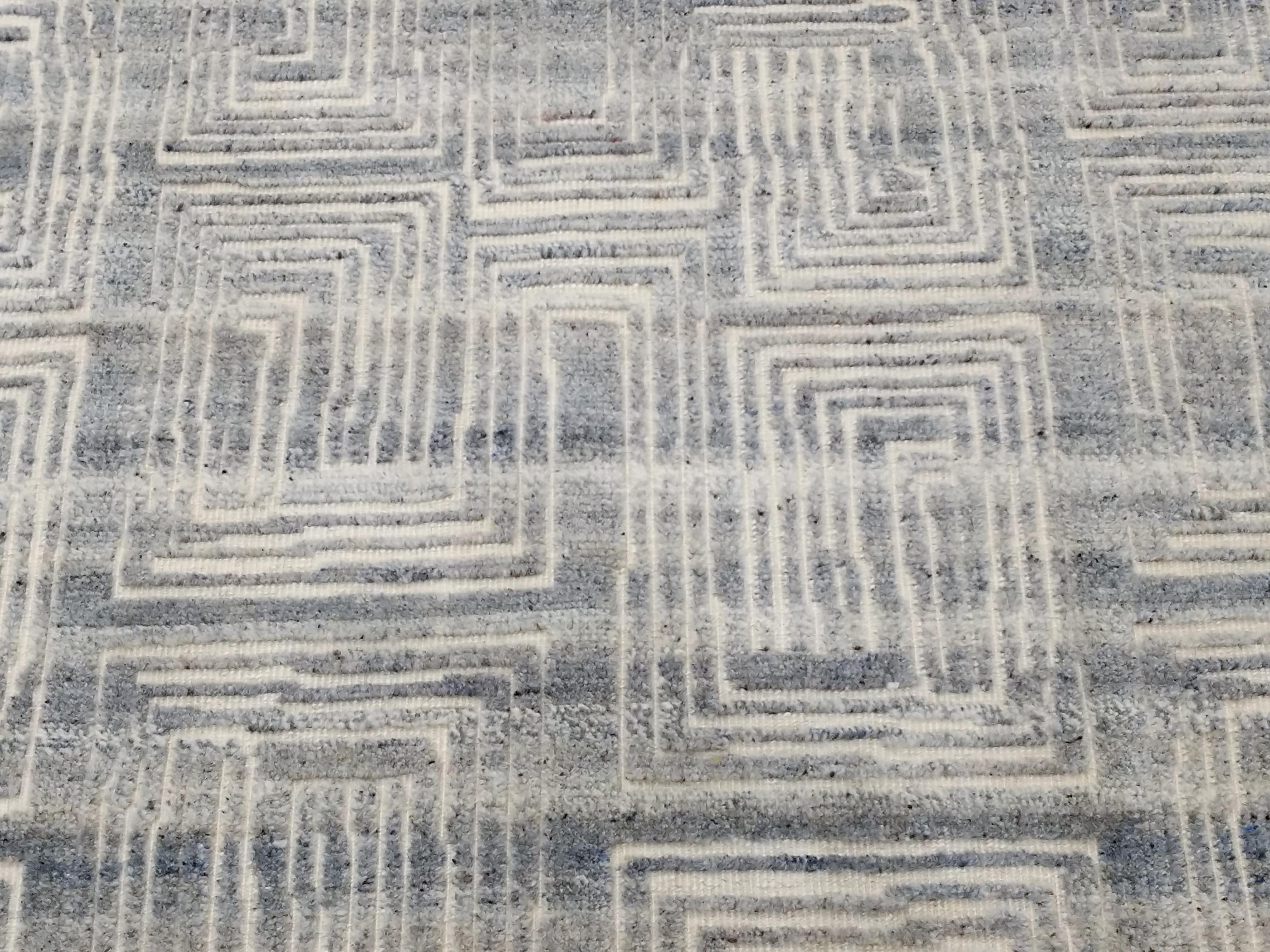 Jules is part of our Textural collection of contemporary carpets inspired by Mid-Century Modern design classics. It is distinguished by a flat-woven ivory background embellished by a raised pile pattern consisting of concentric geometric motifs in