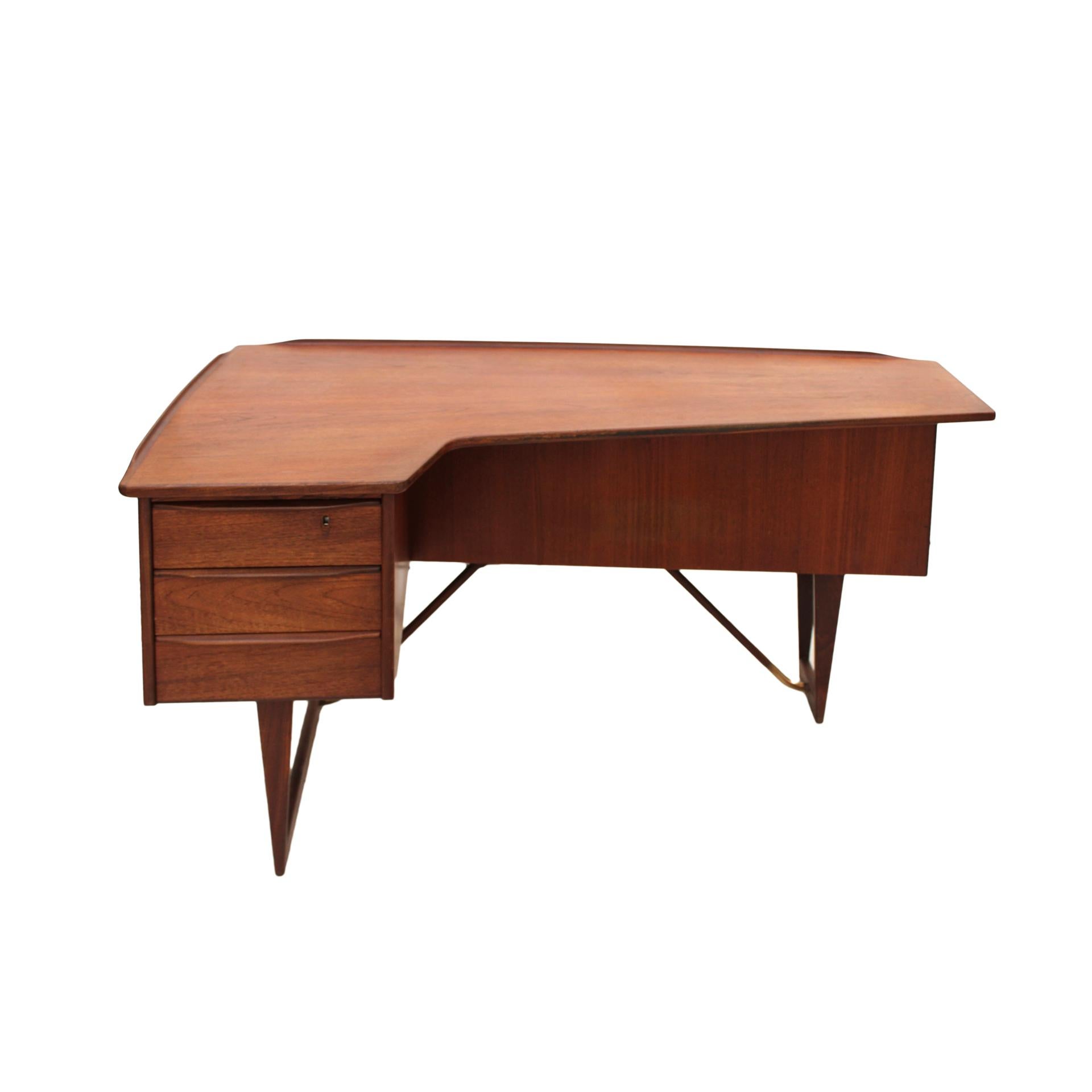 Boomerang desk designed by Arne Vodder. Solid teak wood structure and brass details on the legs. Composed of three drawers and a folding door. Denmark, 1960s.

Bibliography 
Designmuseum – Danmark Furniture Index

Every item LA Studio offers is
