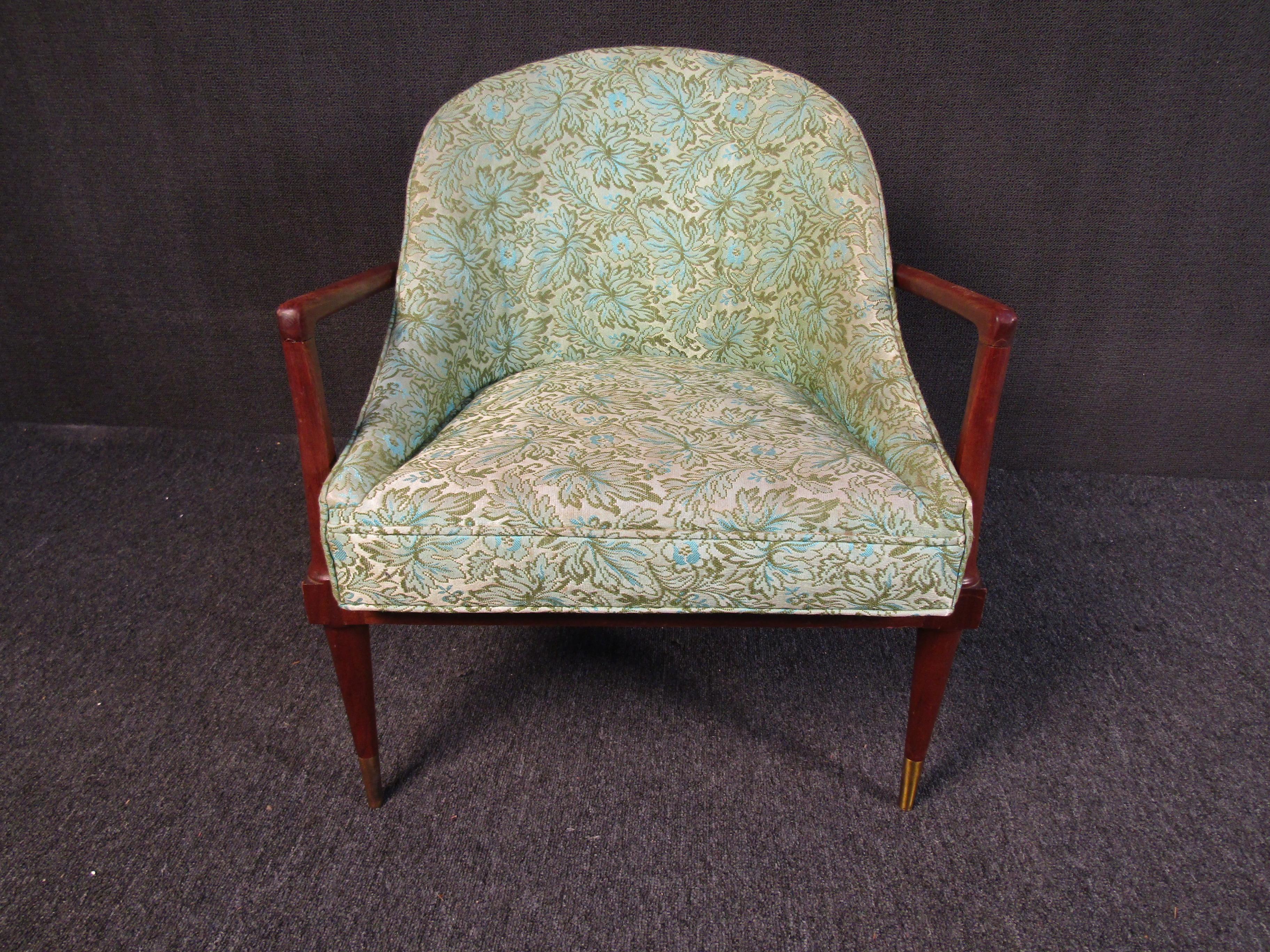 A beautiful Mid-Century Modern armchair with a walnut frame and brass footing caps, this chair features a beautiful combination of materials for a vintage look that is full of character. Please confirm item location with seller (NY/NJ).