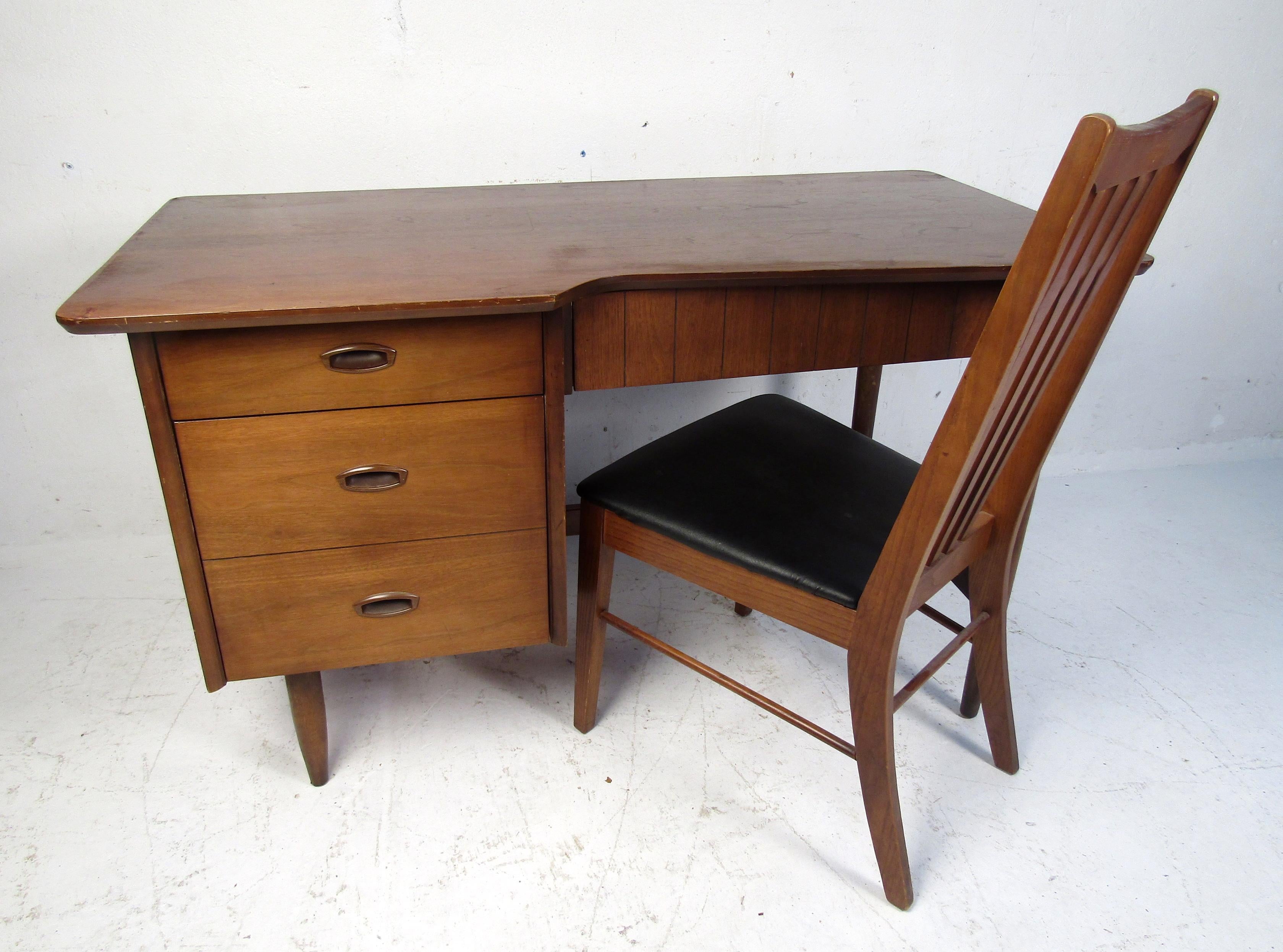 Vintage modern desk and chair featuring rich walnut grain, 3 drawers for storage or documents, comfortable desk chair with a slat back and vinyl cushion.

Chair dimensions: 18.25 W x 22 D x 37 H
SH: 17
Please confirm item location (NJ or BK).