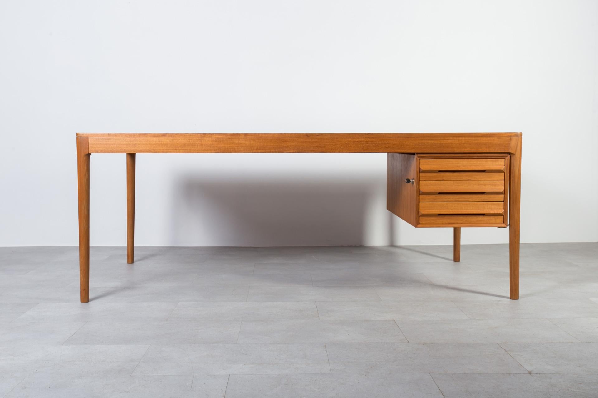This gorgeous Mid Century Modern desk was made in Norway around 1960s. It was produced by Bruksbo manufacture and still has the original manufacture label preserved on the side of one of the drawers. Pure in form yet very impressive. The desk