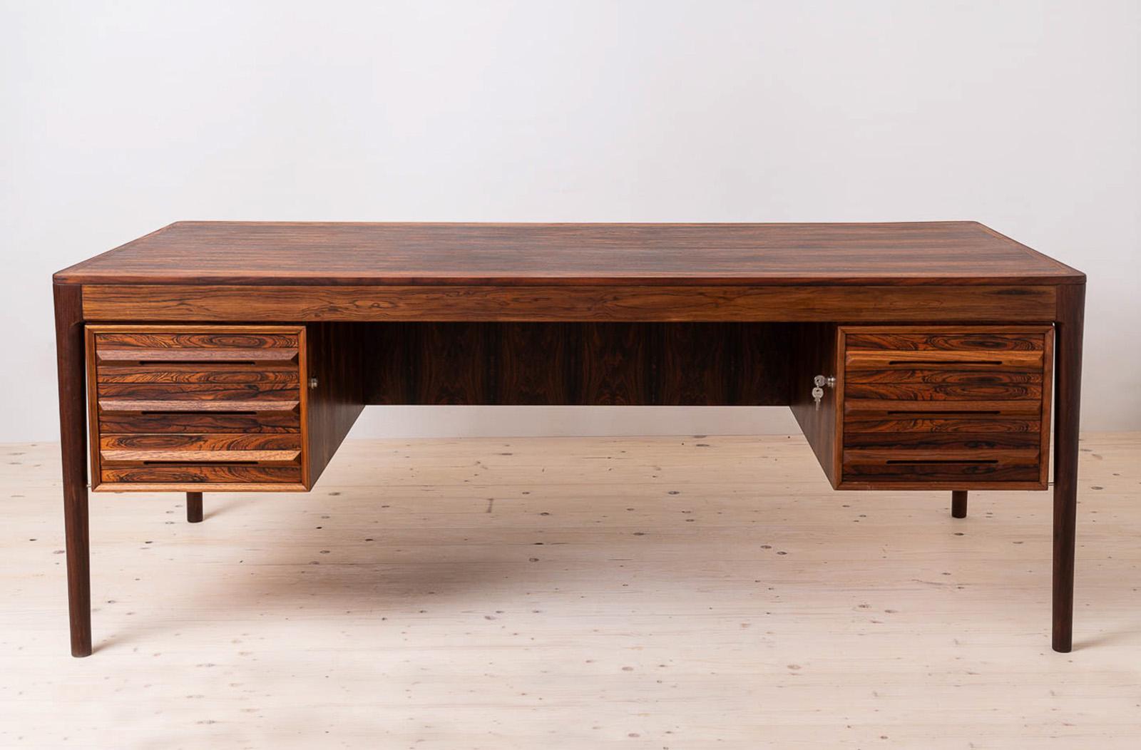 This gorgeus midcentury desk was made in Norway around 1960s. It was produced by Bruksbo manufactory and still has the original label. Pure in form yet very impressive. The desk features two sections with three drawers each with beautifully sculpted