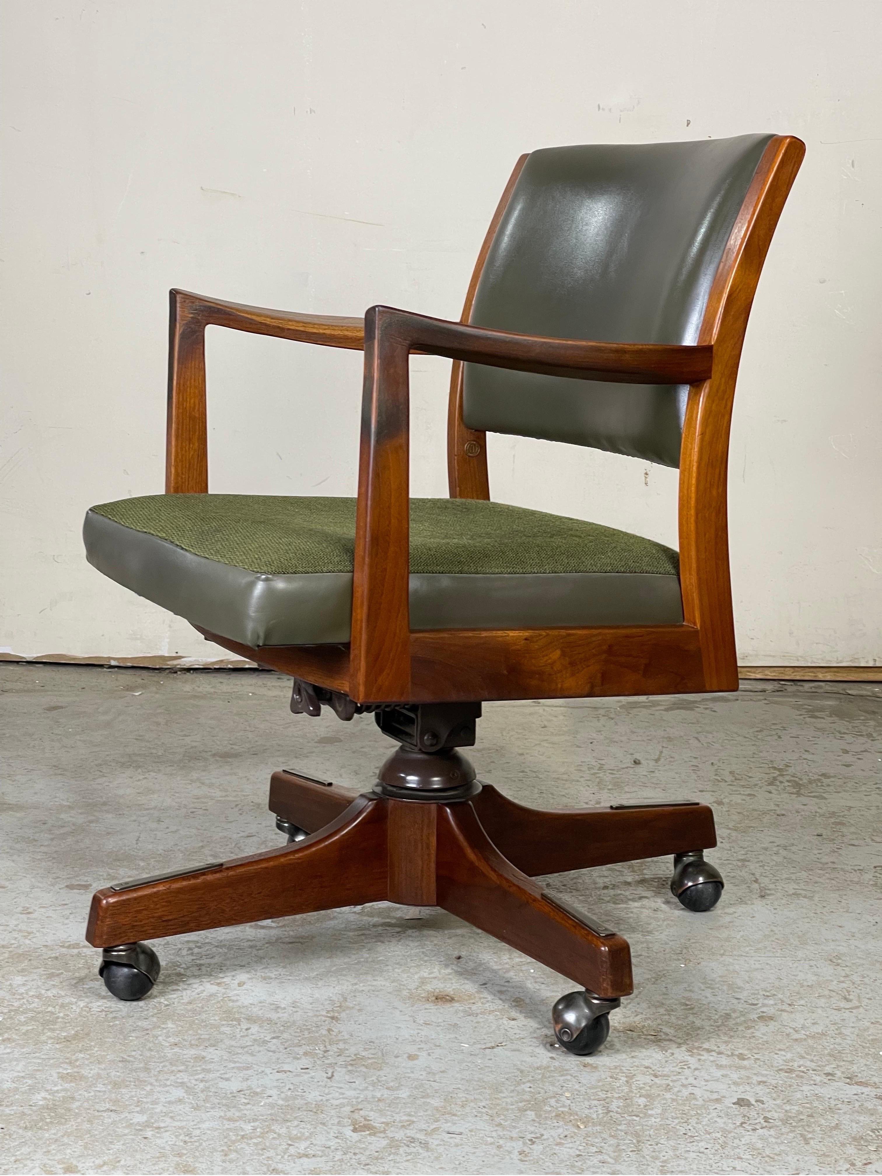 Patina rich swivel and tilt desk chair by Johnson chair Co. Nice wood dowel construction with a lovely base. Very well made and with a lot of age appropriate patina covering the arm rests. 
Measures: 32.5