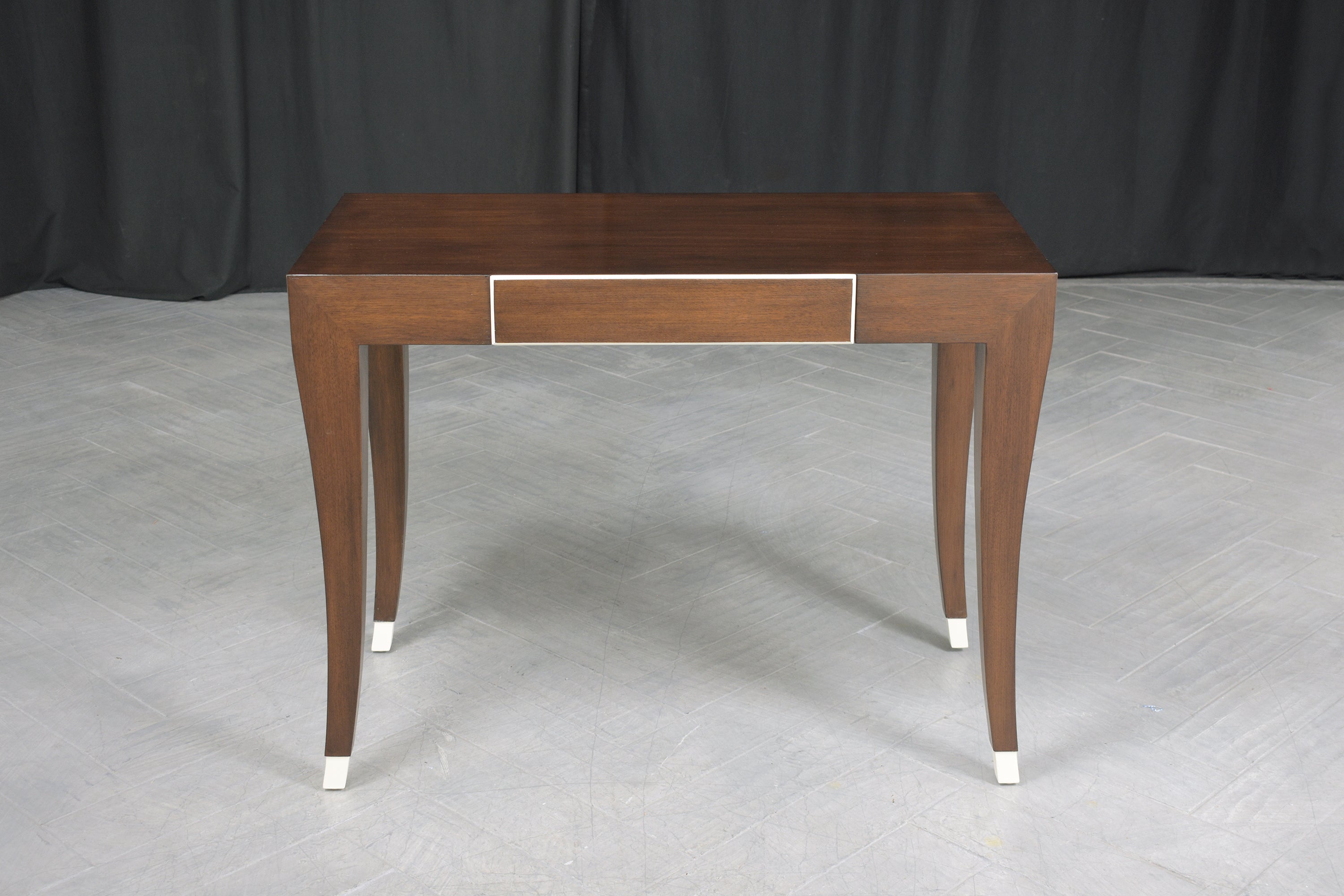 This extraordinary mid-century modern writing table is hand-crafted out of mahogany wood and is in great condition has been completely restored and refinished by our professional expert craftsman team in the house. This executive desk is sleek and