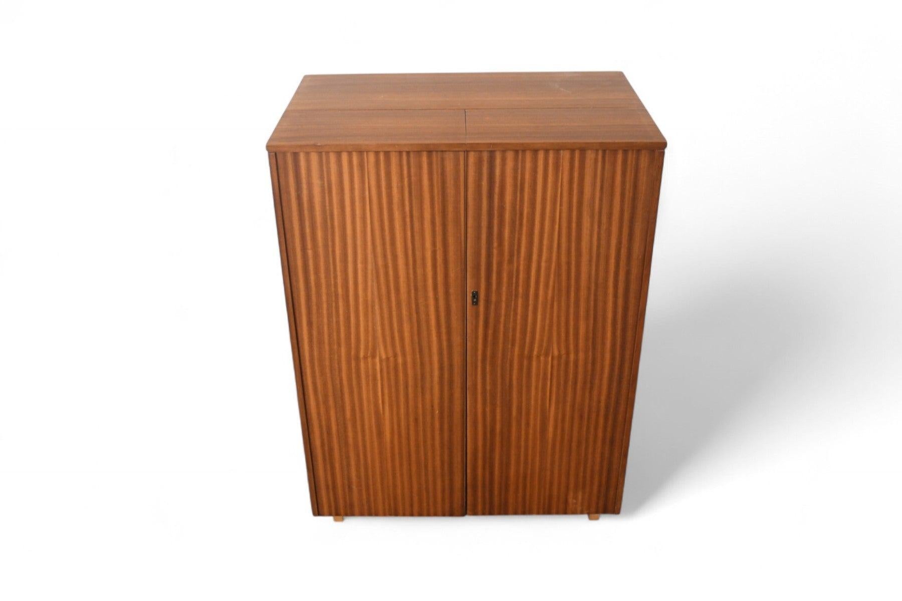 Origin: England
Designer: Unknown
Manufacturer: Newcraft Ltd.
Era: 1960s
Materials: Mahogany 
Measurements:
Closed: 33
