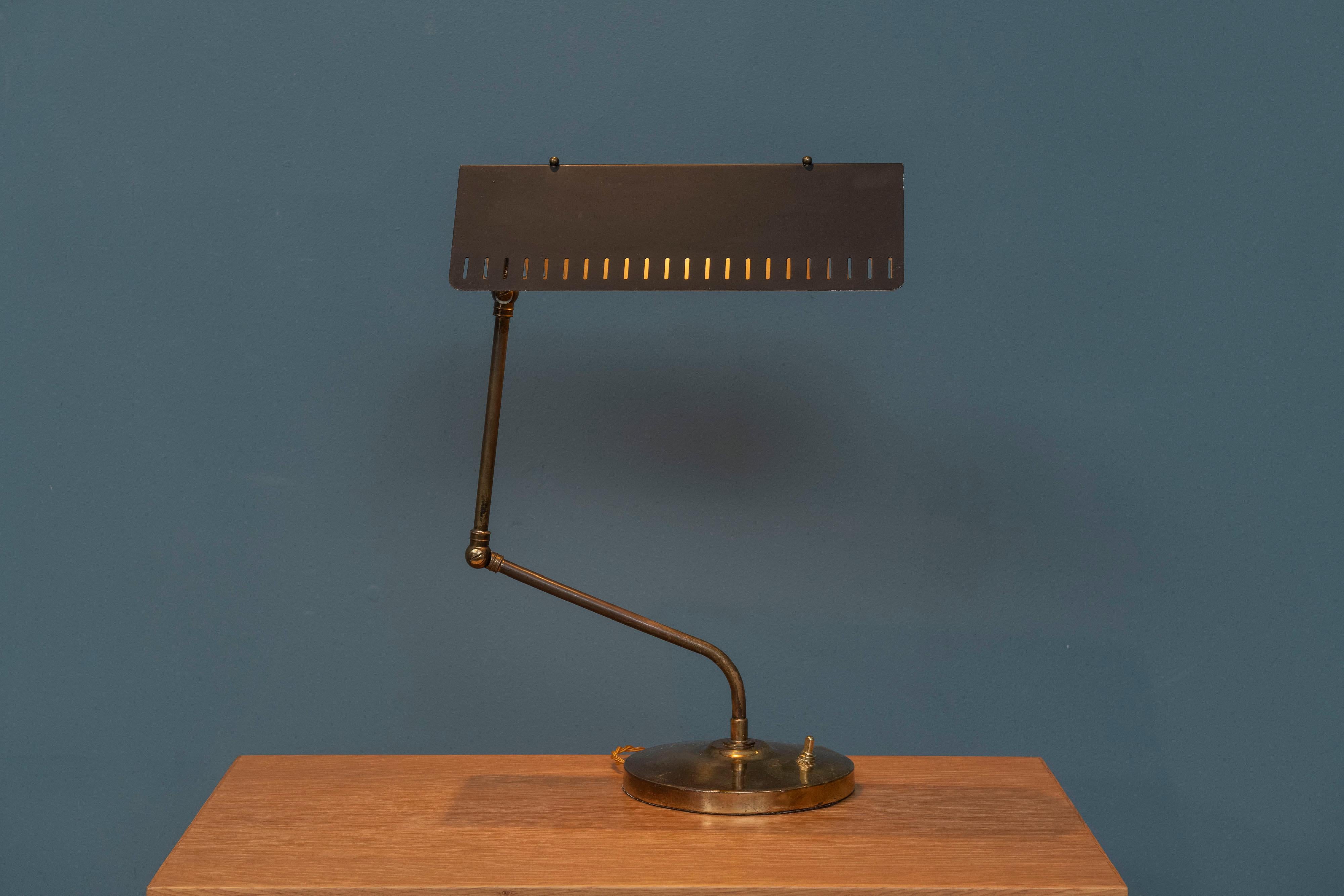 Mid-Century Modern brass and enamel articulating desk lamp. Interesting design that pivots, and adjusts to your desired height, most likely French in origin just newly rewired and ready to install.