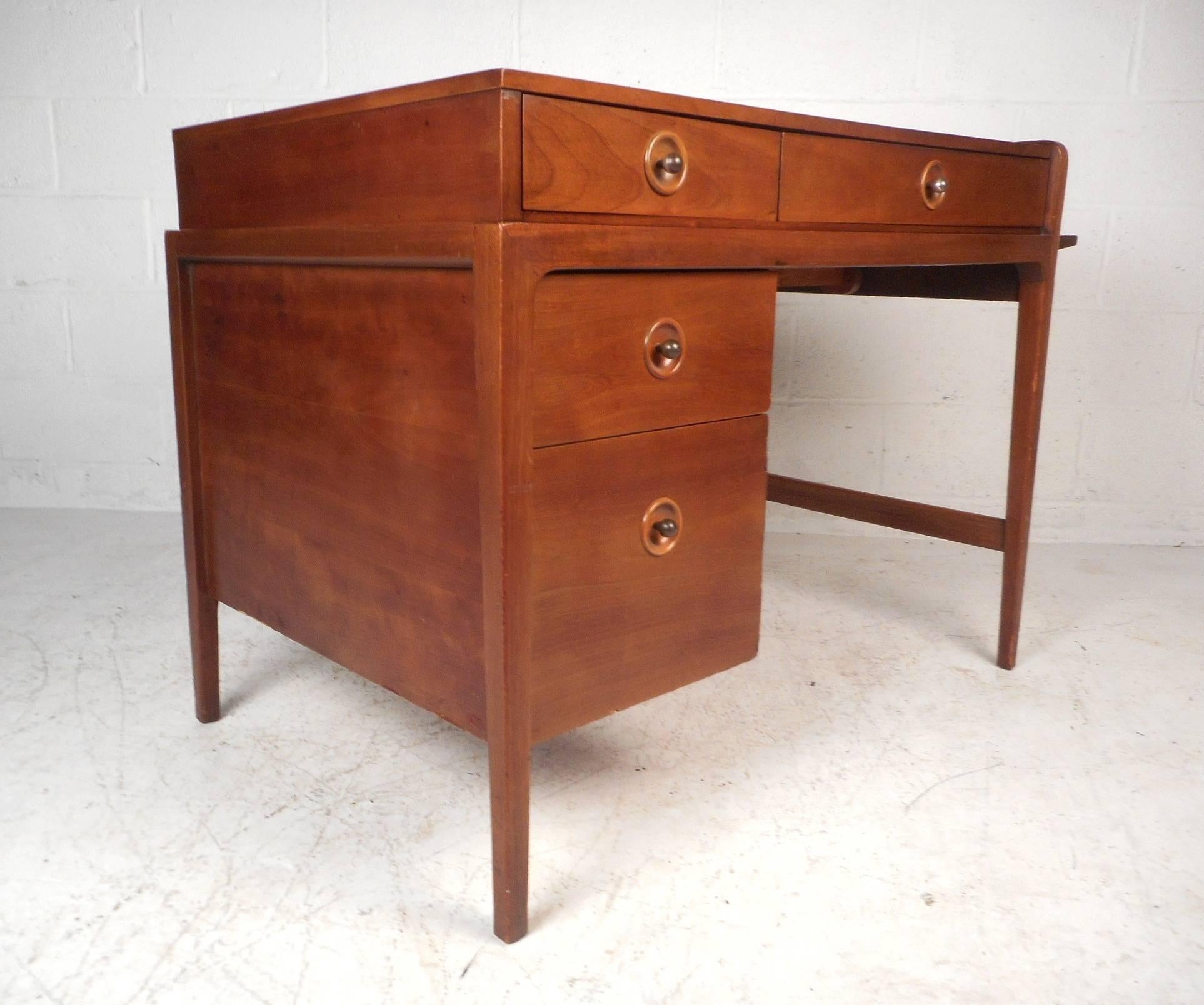 This gorgeous vintage modern desk features a side extension making the width go from 39.5 inches to 62 inches. Unusual design provides an abundance of work space with the option to retract the side saving room. This handsome case piece has recessed