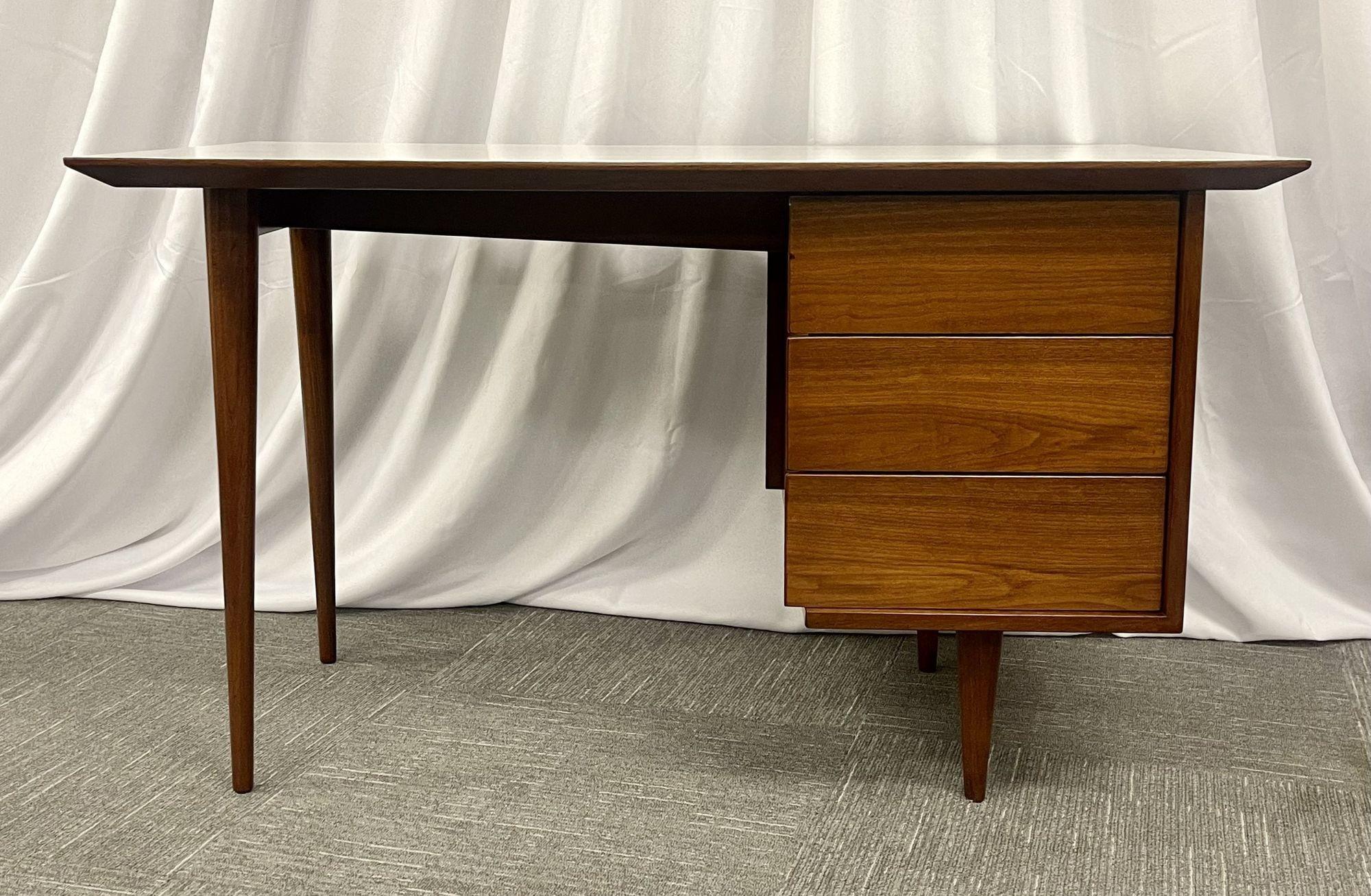 Mid-Century Modern Desk / Writing Table, Paul McCobb, Walnut, American, 1950s
 
Having a Large kneehole with Three drawers on one side supporting a white laminate table top writing surface. Finished back. Bearing label on interior drawer. 
 
Other