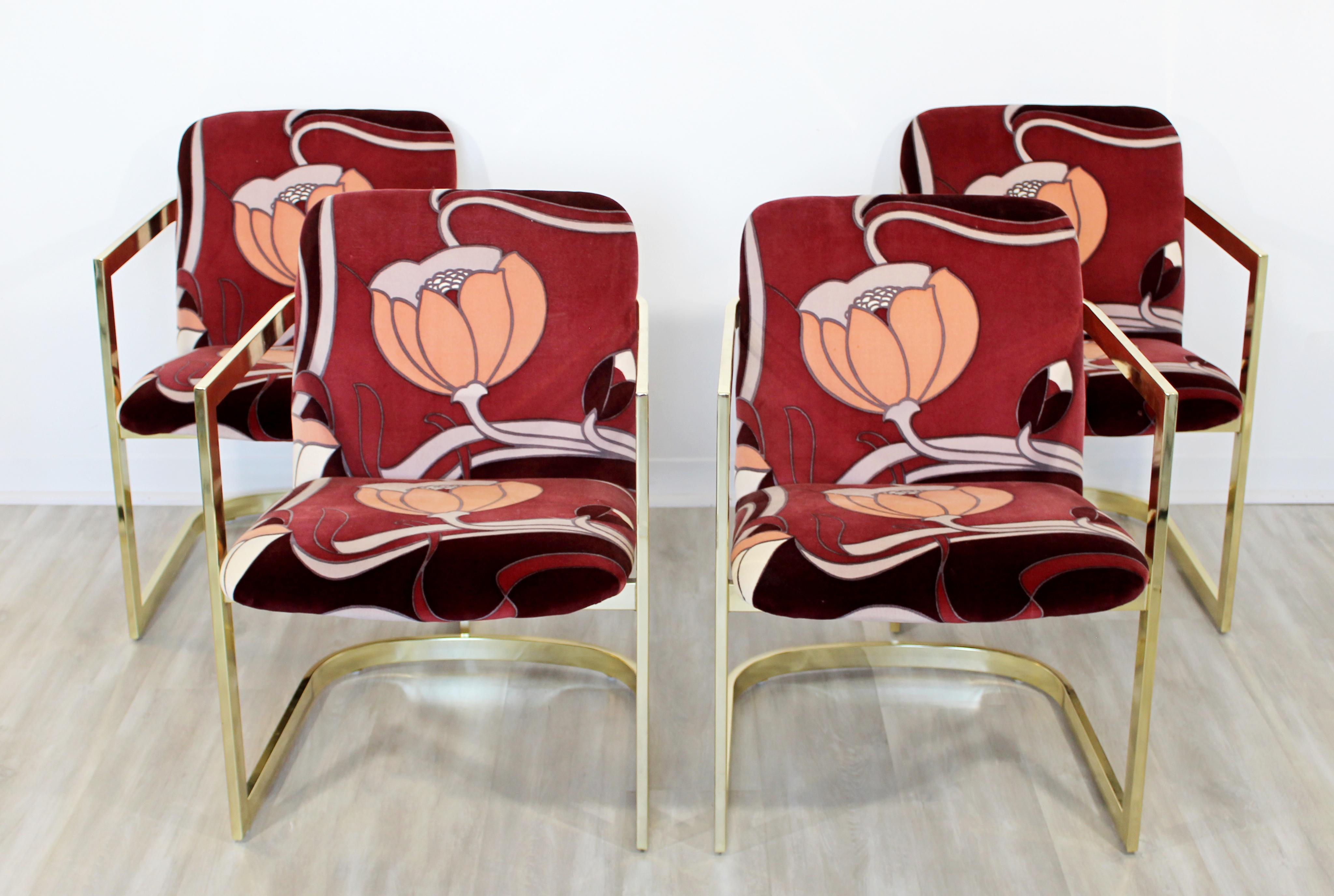 For your consideration is a rare set of four dining armchairs, made of curved cantilever brass and with Jack Lenor Larsen fabric, by the Design Institute of America, circa 1970s. In very good condition. The dimensions are 22