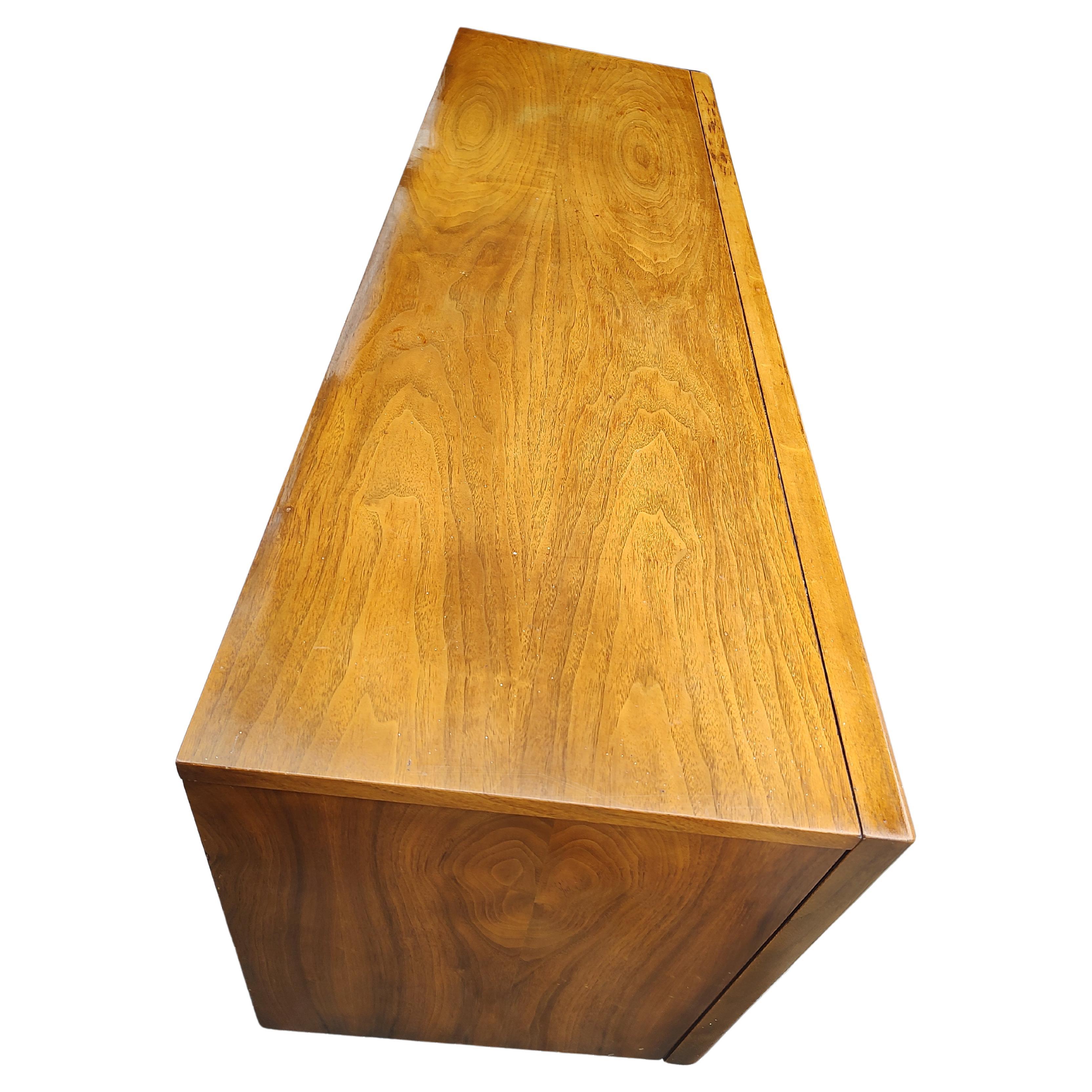 Fantastic walnut diamond faced triple dresser by the United Furniture Co. with a full length beveled mirror framed in walnut. Triple Dresser with nine drawers which when fully closed make up a trio of diamonds. Dresser was well cared for and