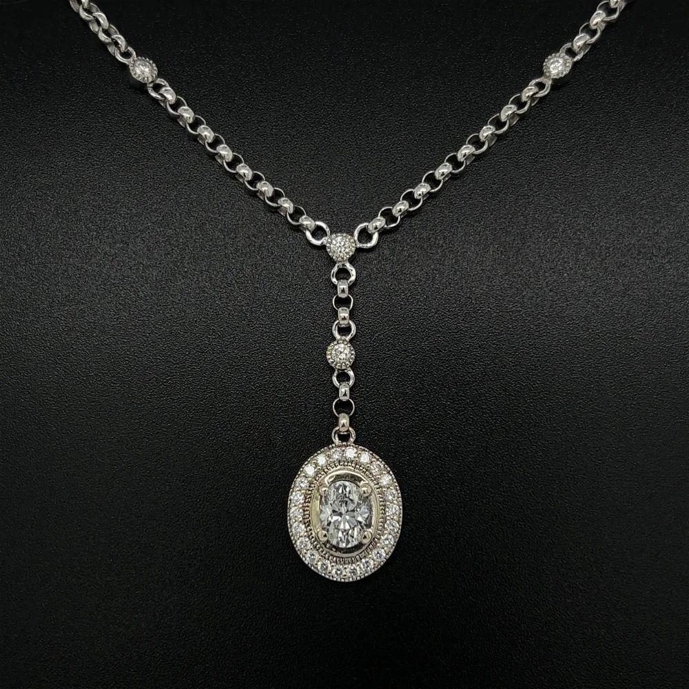 Simply Beautiful! Mid Century Modern Diamond Gold Drop Pendant Necklace. Center securely Hand set Oval Brilliant cut GIA Diamonds, approx. 0.75 Carat G-SI1 and 2.69 Carat GIA # 1206738346. Surrounded by Diamonds approx. 0.52tcw. Suspended from a