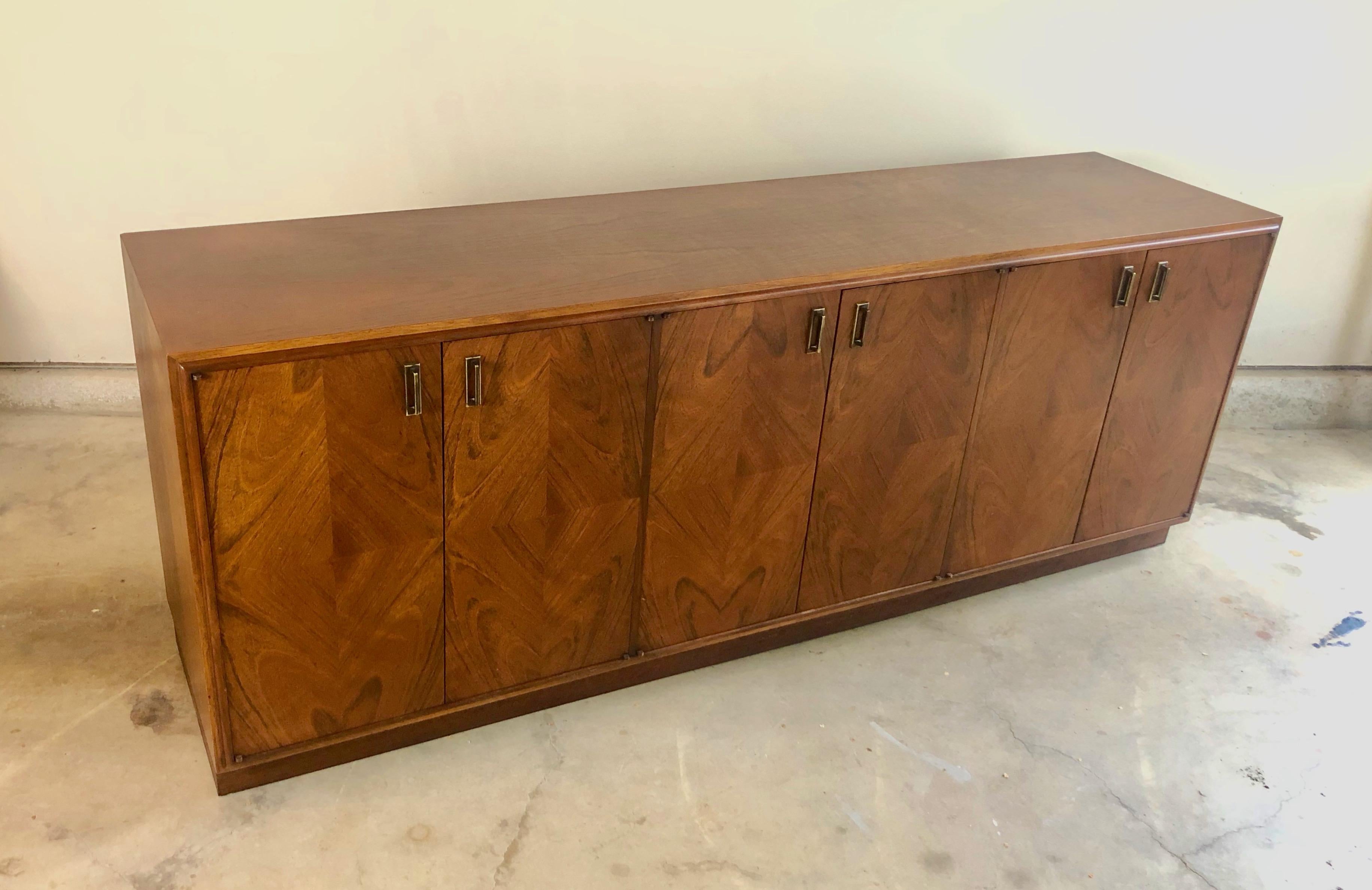 Mid-Century Modern diamond parquet credenza/buffet with brass handles. Center section has drawers with adjustable shelves on each side.
     
