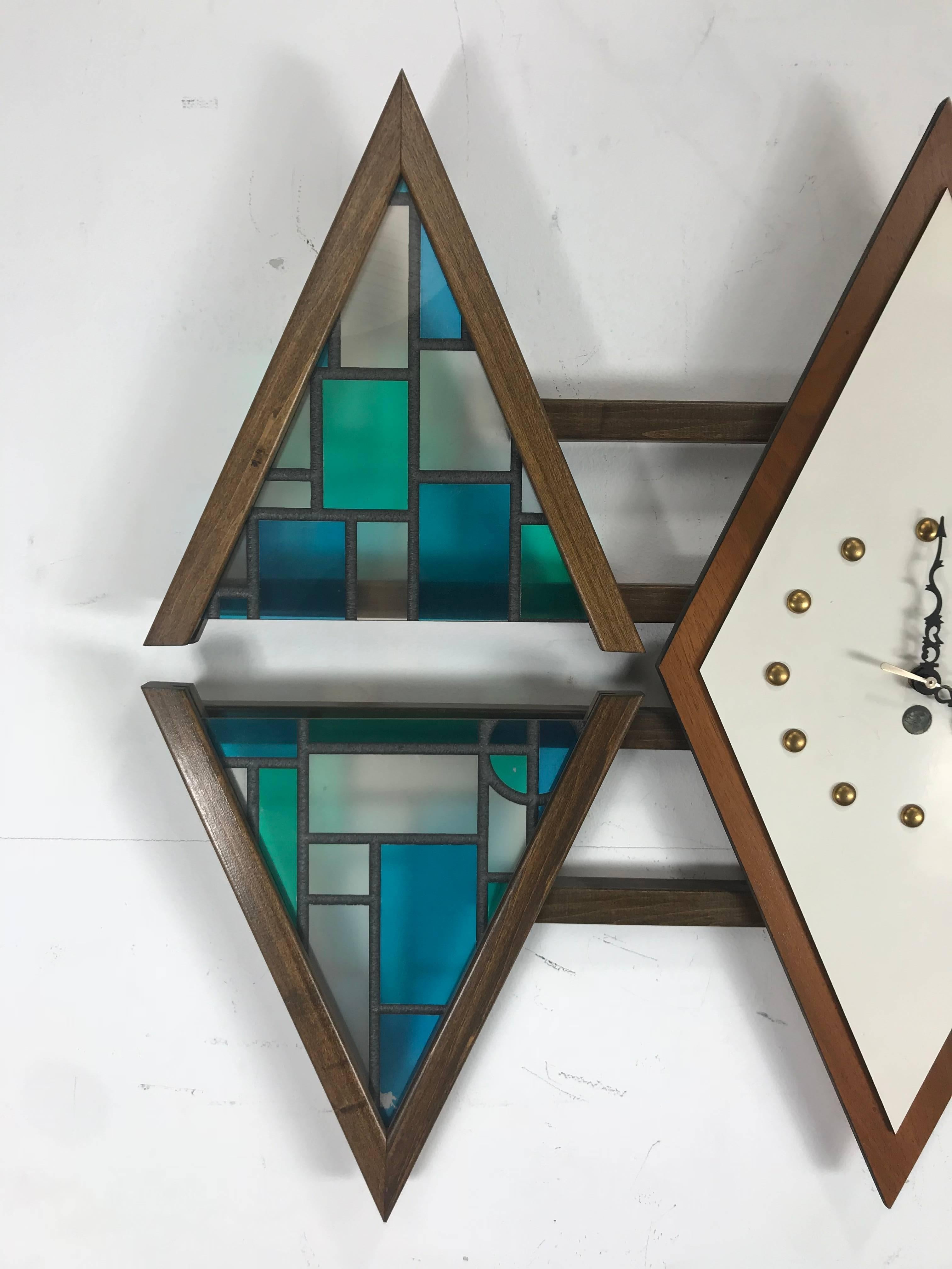 Unusual Mid-Century wall clock made by Penthouse Art Creations, triple diamond design, tinted plastic inserts to mimic stained glass, battery operated, tested and keeping perfect time.