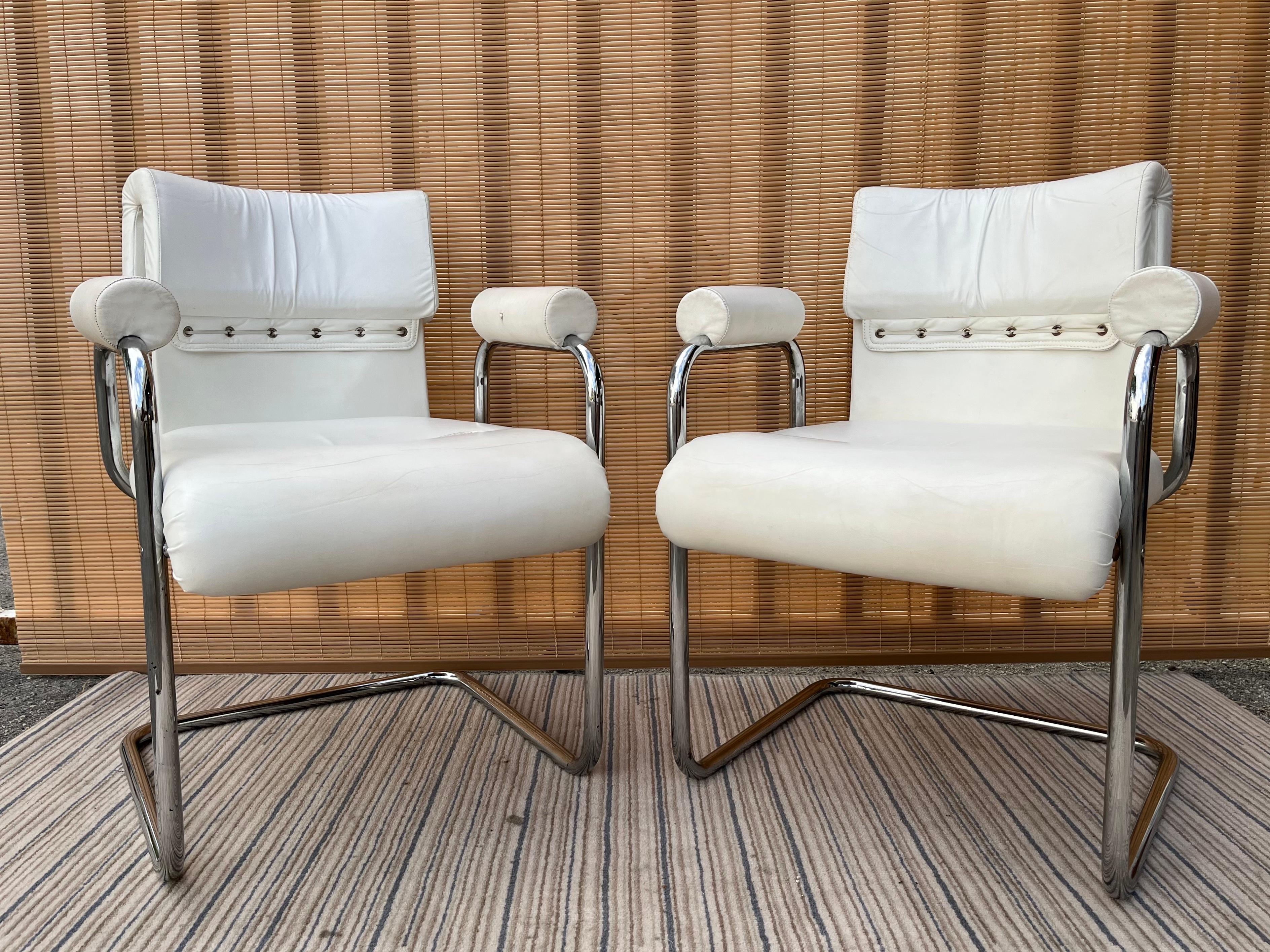 A pair of Iconic Mid-Century Modern Teorema dining armchairs Design by Guido Faleschini and exclusively manufactured by i4Mariani for The Pace Collection. Circa 1970s 
The armchairs feature a cantilever design with a chromed steel tube frame, they