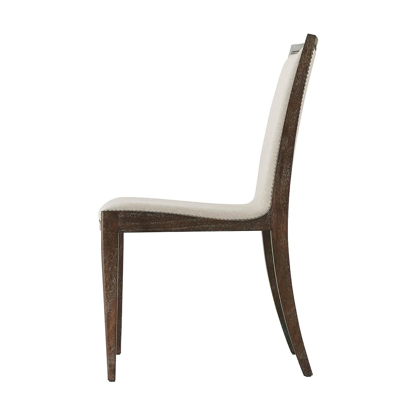 Mid-Century Modern style mahogany mesquite finish dining side chair with a slung upholstered seat and back, iin cream hide leather and oatmeal linen, finished with antiqued steel nail head trim.
Each Hide has natural variations
Dimensions: 22