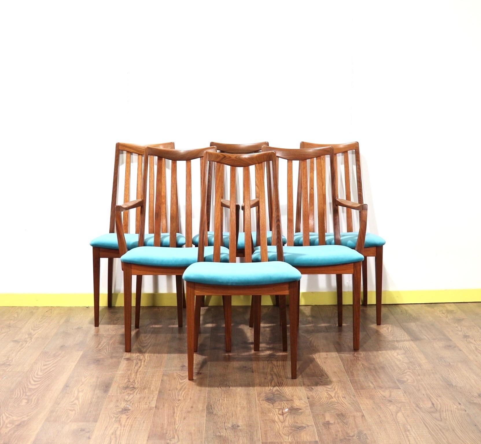 A gorgeous set of 6 G Plan teak framed dining chairs from their Brasillia range. These fabulous chairs have had the seat pads recently upholstored in teal to give them a really striking look. They would look great in any dining room.

