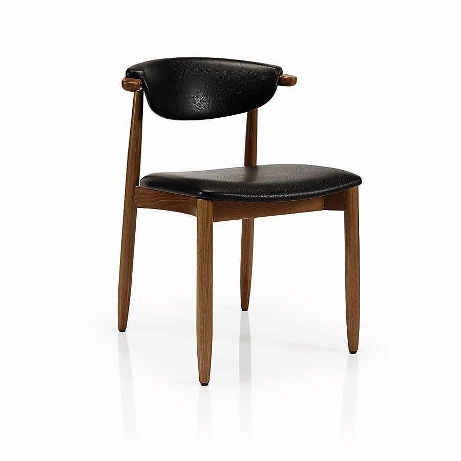 Mid-Century Modern curved back dining chairs upholstered in black faux leather. 
Crafted of solid black wood frame for either casual or formal dining room or kitchen. 
This chair is heavily constructed and suitable for contract use.
100% European