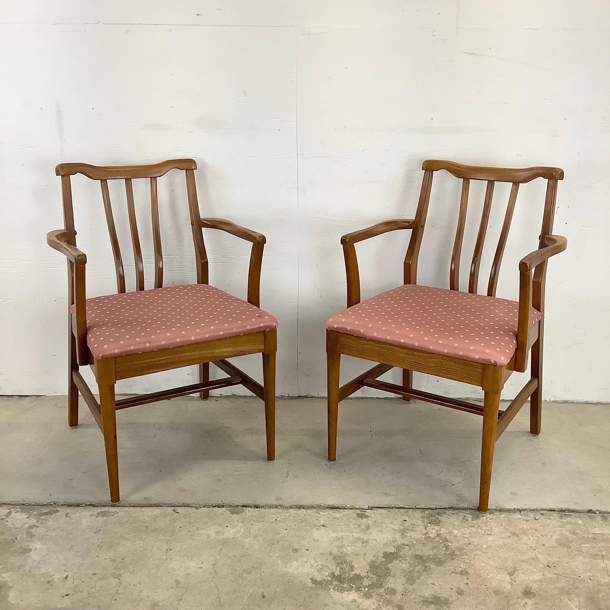 This striking set of eight mid-century modern dining chairs feature low back design with sculptural walnut details and comfortably proportioned seats. Vintage upholstery can be easily recovered while the timeless danish modern style of this matching
