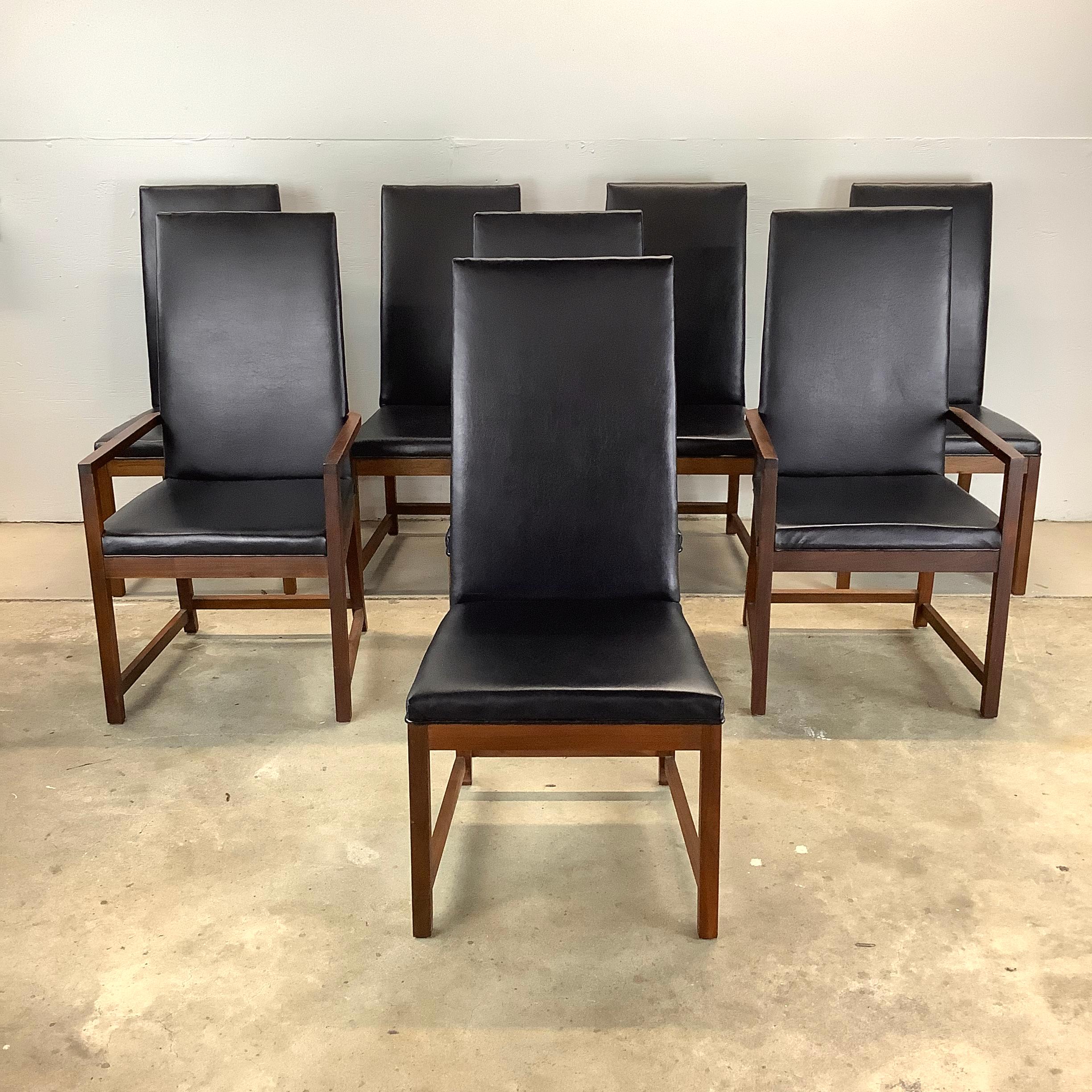 This stunning set of eight highback mid-century chairs, each crafted with a beautifully finished walnut frame and upholstered in durable, easy-to-clean vinyl. These chairs are the epitome of mid-century modern design, combining timeless aesthetics