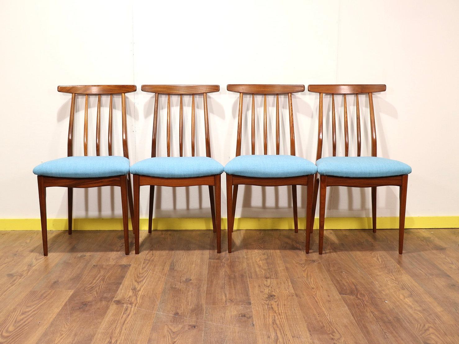 A really stunning set of 6 dining chairs made by British furniture maker A . Younger in the 1960s. The set includes 2 carver chairs and 4 standard back chairs, they have been recently upholstered in blue these dining chairs would look fantastic