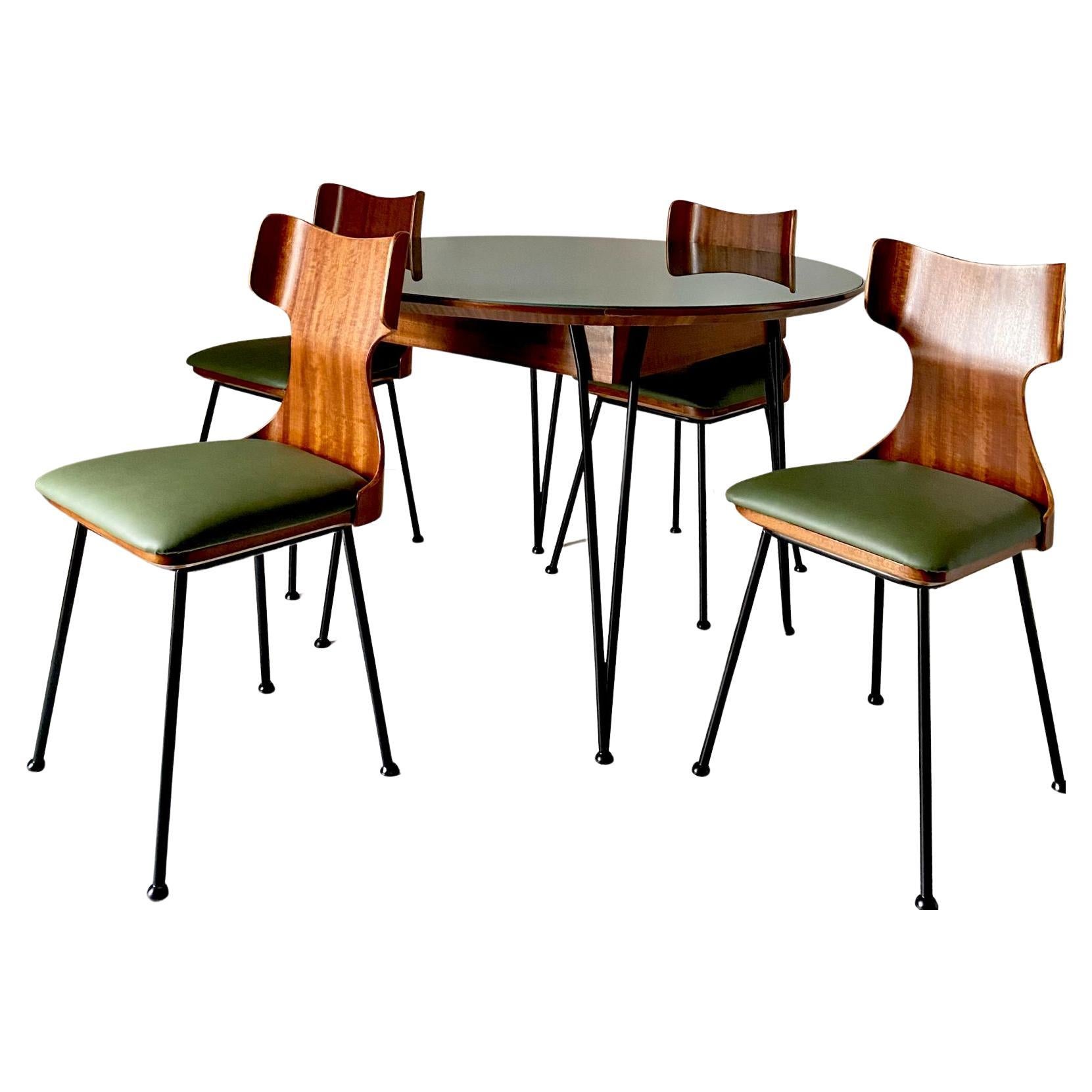 Very Rare Mid Century Modern Dining Room Set designed by Carlo Ratti,  for Industria Legni Curvati, Italy 1950 's.

Four terrific curved bentwood chairs with black iron structure and dark green faux leather seats along with a cozy round table with