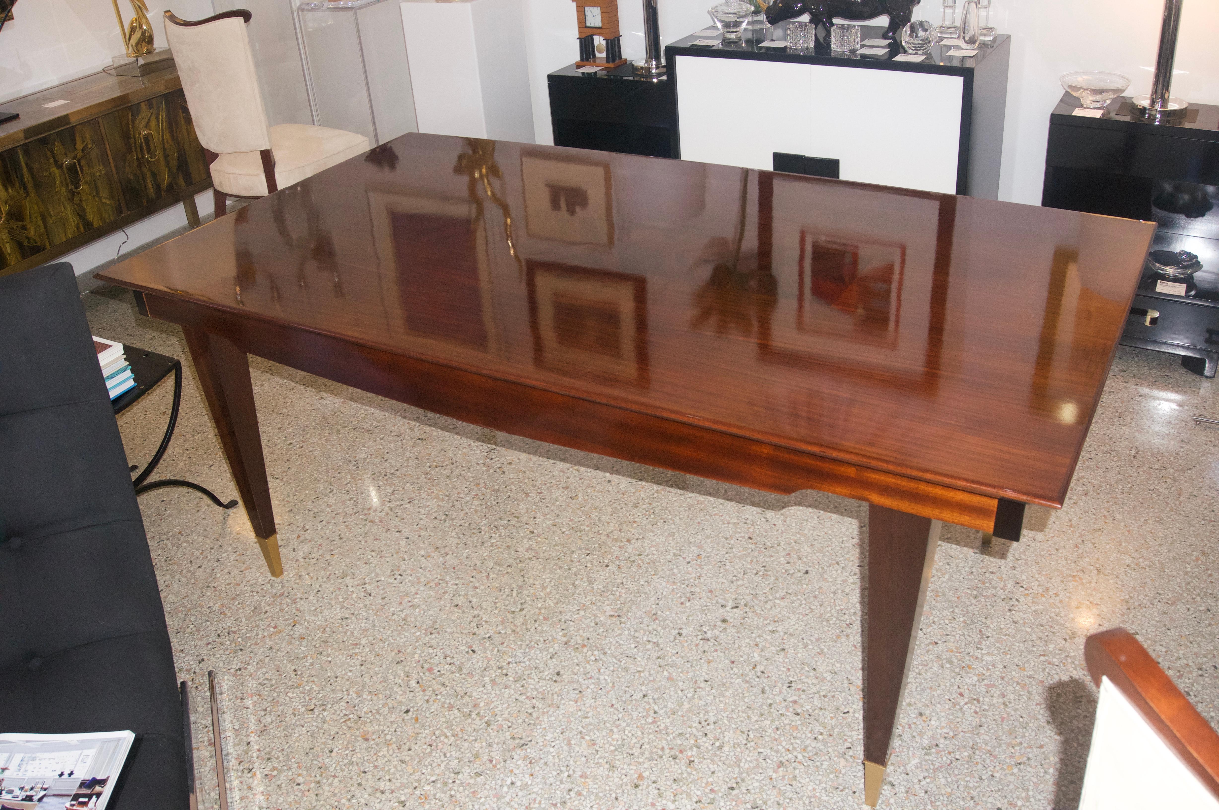 This stylish and chic dining table is very much in the style of pieces created by the Italian, furniture designer Paolo Buffa. The piece has been professionally refinished and restored. The restoration included the addition of two extension leaves