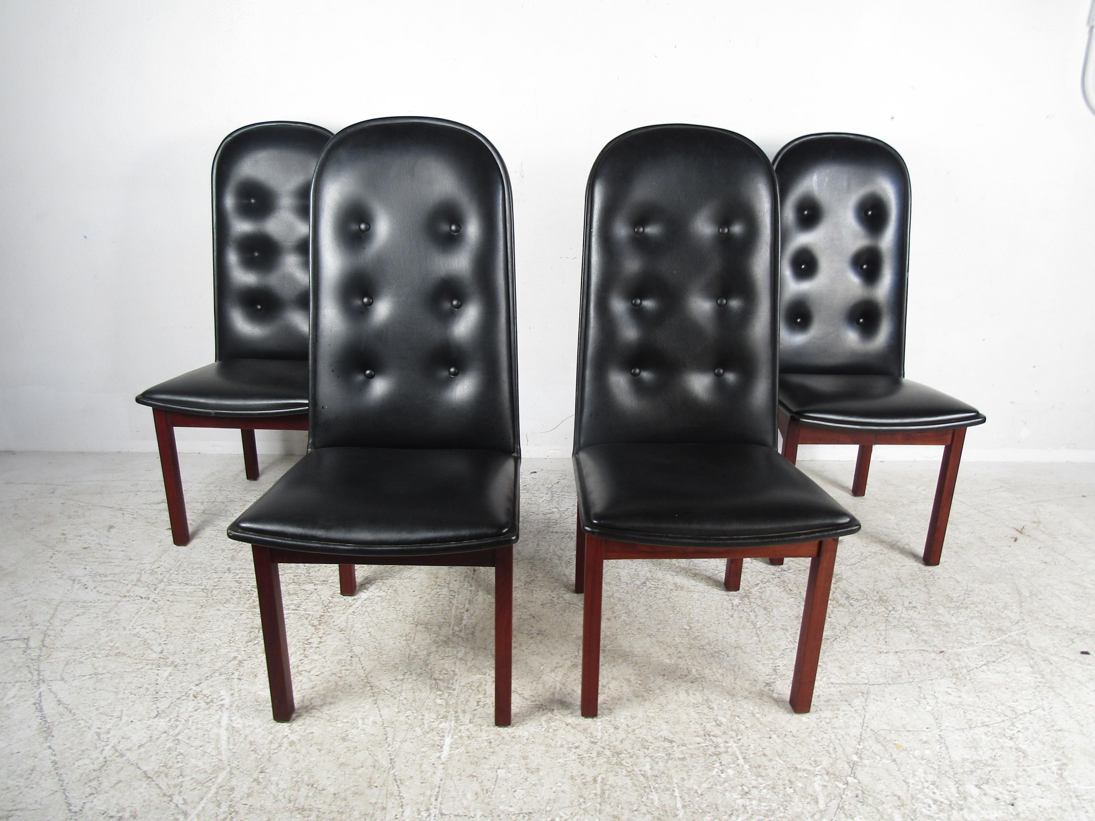 Nice Mid-Century Modern dining set. Danish modern dining chairs made by Domino Mobler, with rosewood frames and tufted black vinyl upholstery. Spacious table with two leaves; each leaf adds an additional 20 inches to the table's width. Please