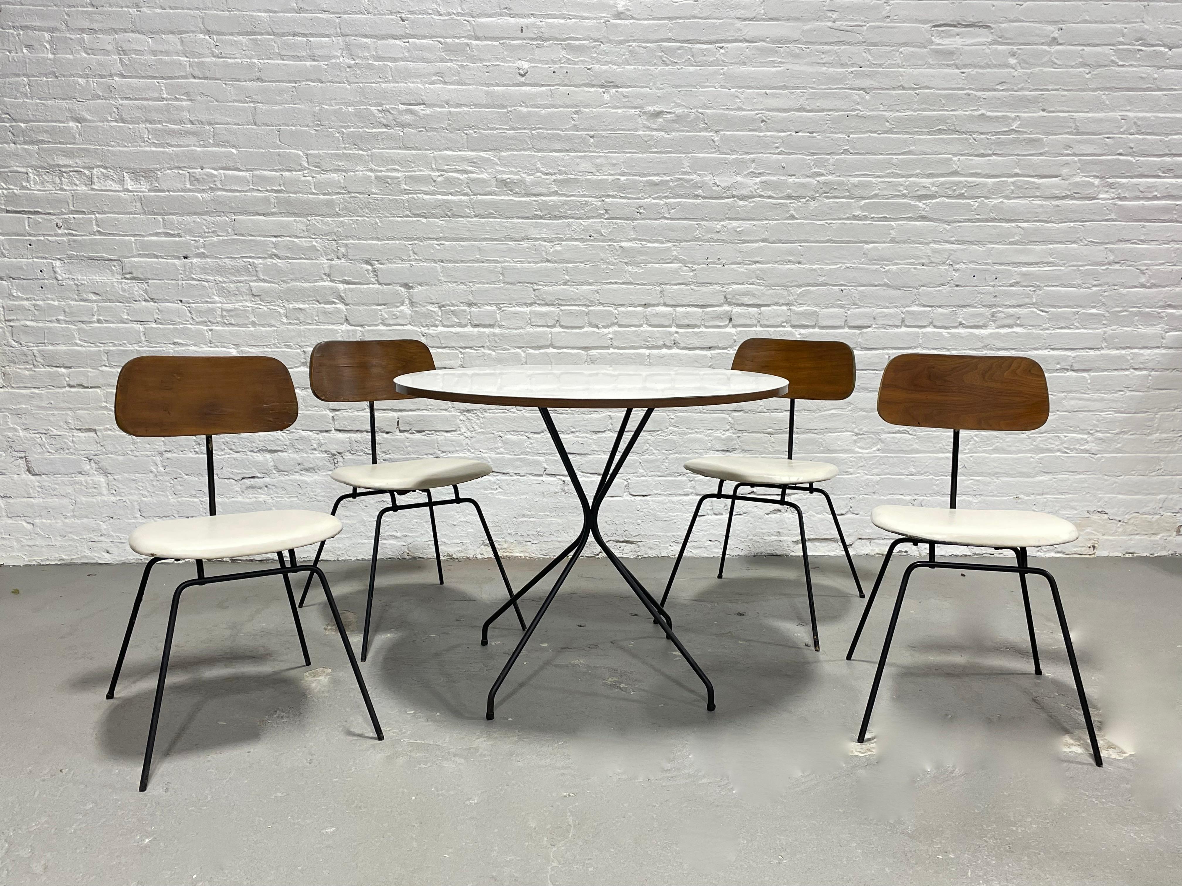 Mid-Century Modern Dining Set in the style of Clifford Pascoe, c. 1960s. This unique set is perfectly sized for smaller spaces and consists of 4 dining chairs and round dining table, all with solid + sturdy black iron bases. Incredible and rare set,