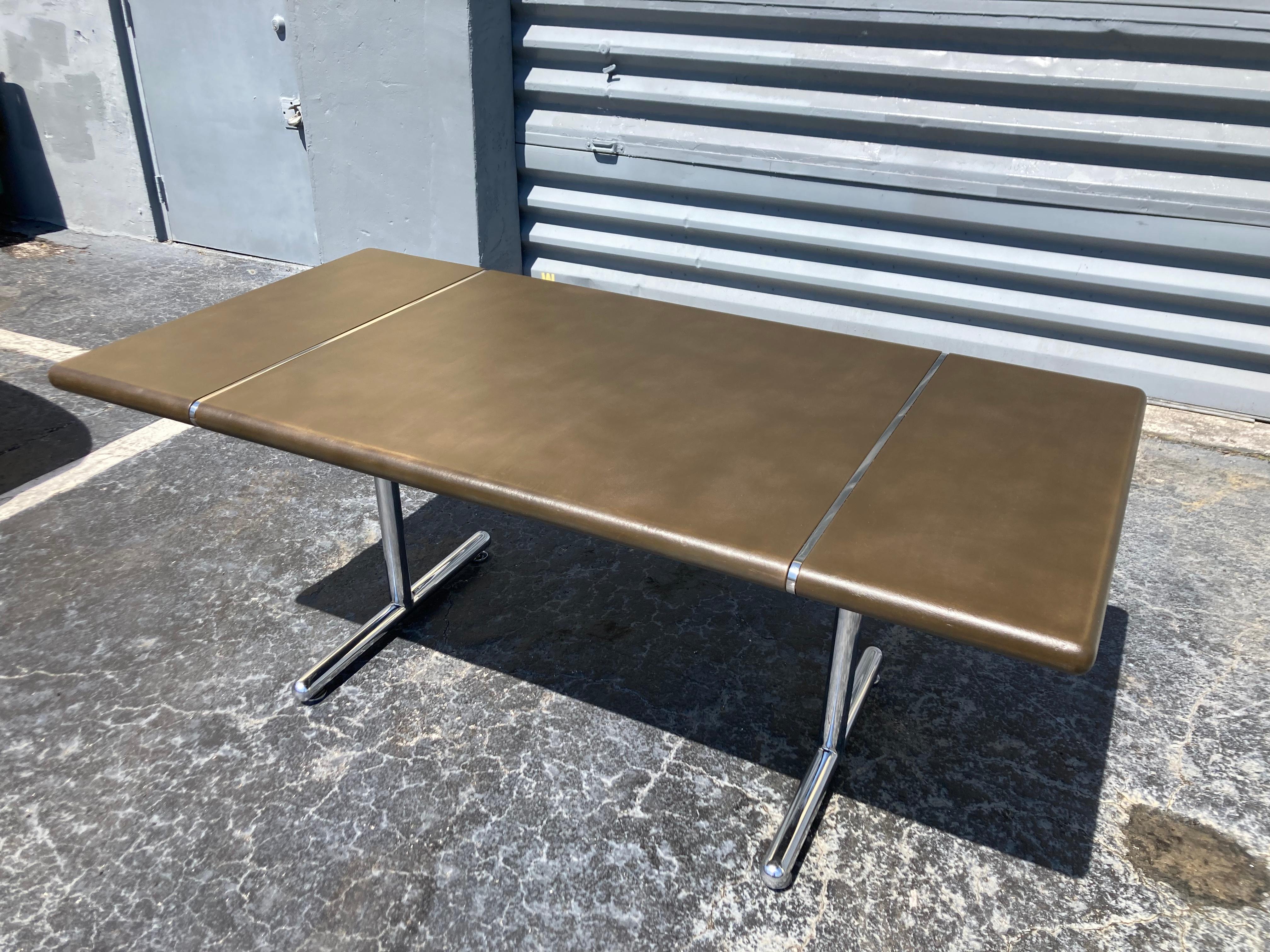 Great leather top table with chrome base. Leather has a green brown color with a rich patina. Please see pictures. High-quality. Ready for a new home.