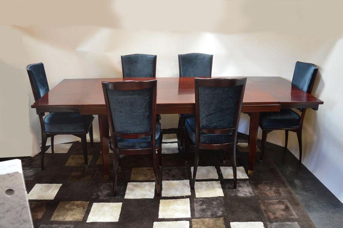 Mid-Century Modern dining table. Legs of the mahogany table are capped and accented with brushed brass feet.
The tables full width with extensions is 90.5 inches.