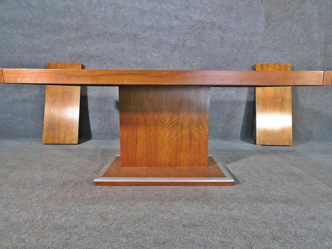 Vintage modern extendable dining features a pedestal base and comes with two 16