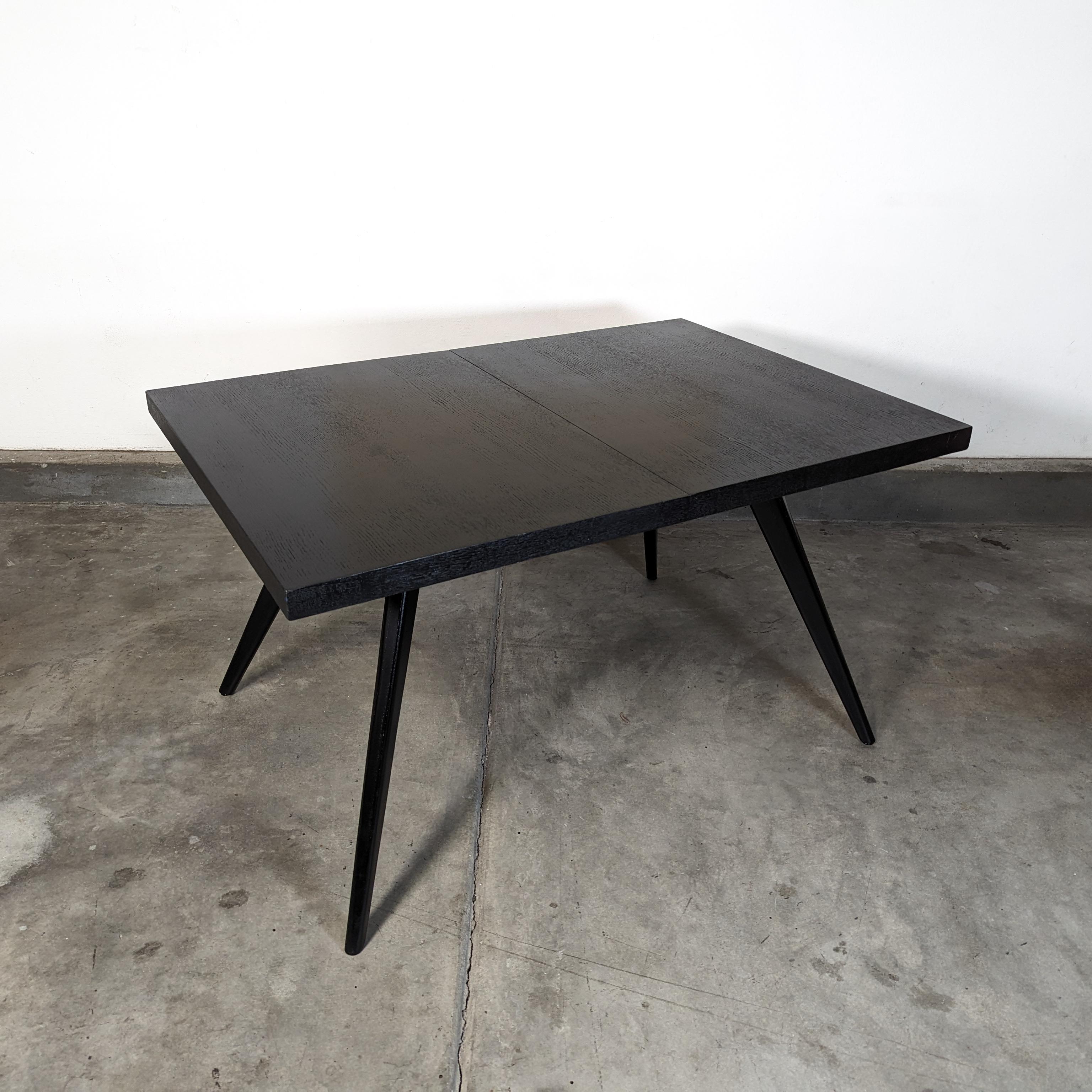 Introducing an immaculate piece of history with this vintage Mid-Century Modern ebonized dining table from the 1950s. A testament to the era's design ethos, this table is a stunning addition to any dining space. It boasts long, gracefully cambered