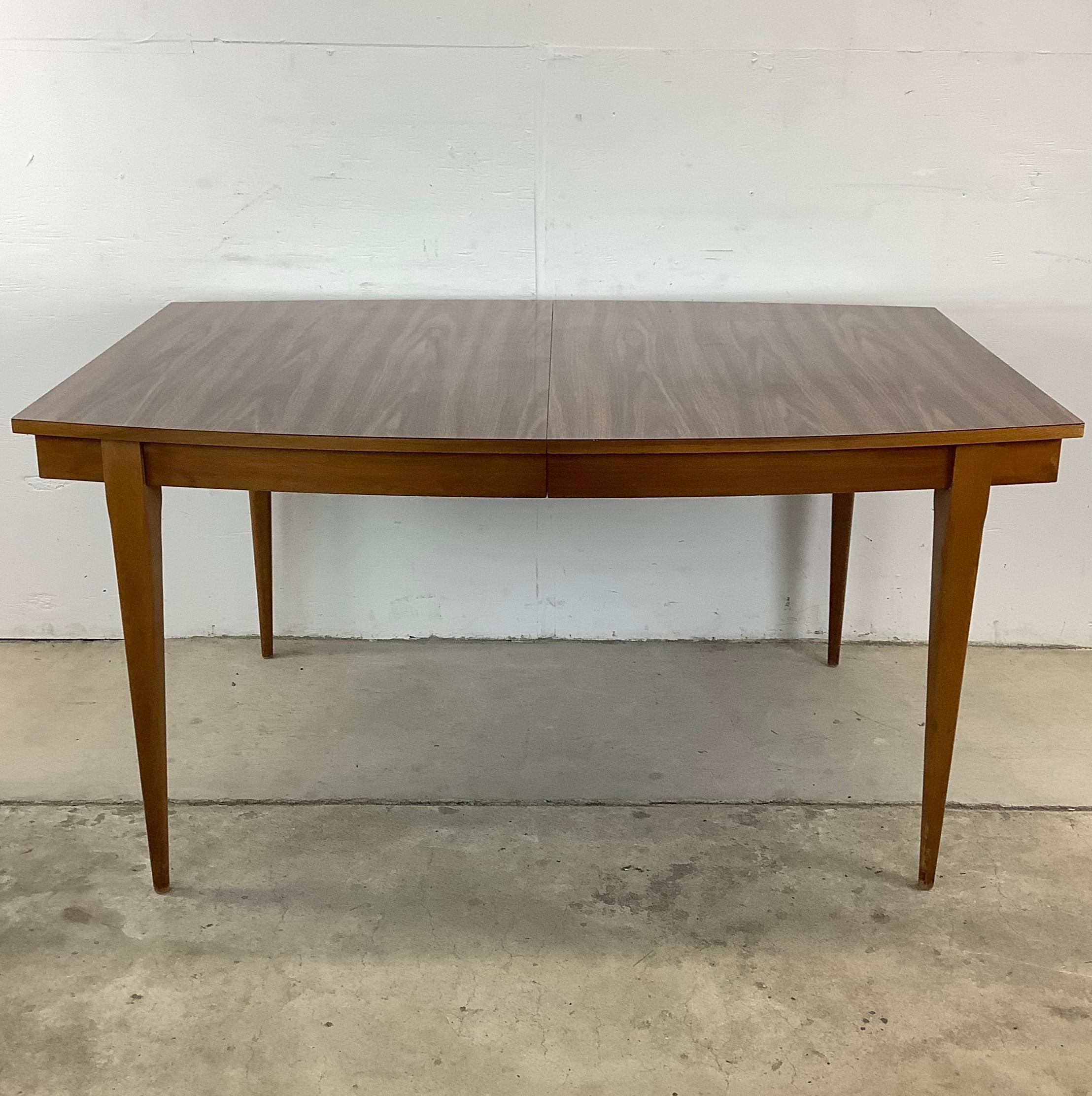 Introducing a captivating addition to any dining space – this Mid-Century Dining Table with durable formica style top and removable leaf for extra seating. This table seamlessly combines functionality with flair, promising to elevate your home decor