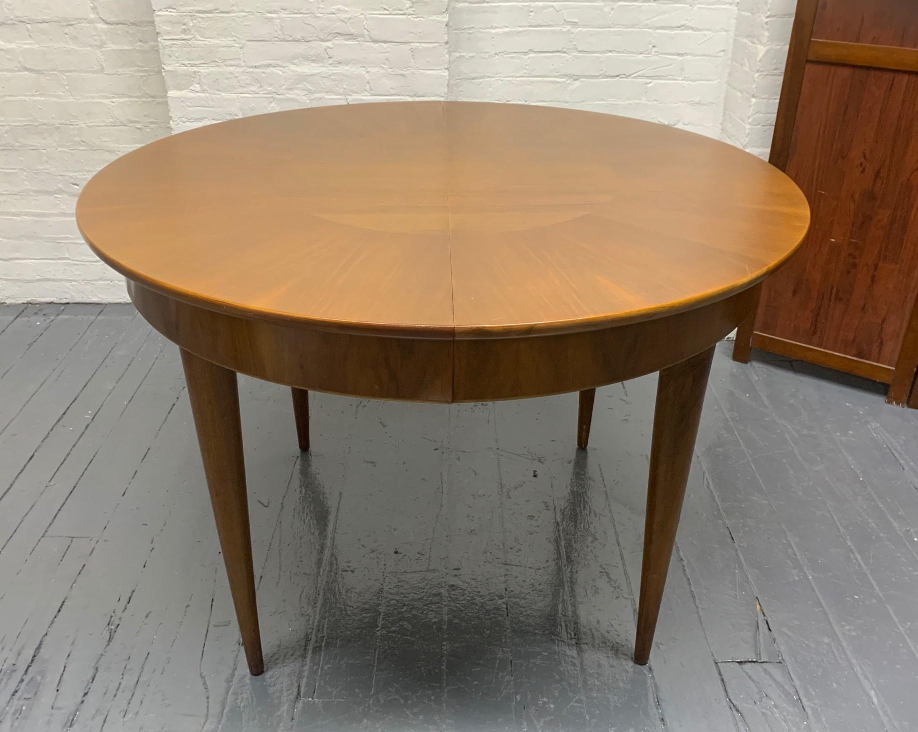 Mid-Century Modern dining table with three extension leaves. Nice walnut grain with eight tapered legs. 
Fully extended: 101 W x 43 D x 29.5 H. 
Each leaf is 19.5 W
Table without leaves: 43