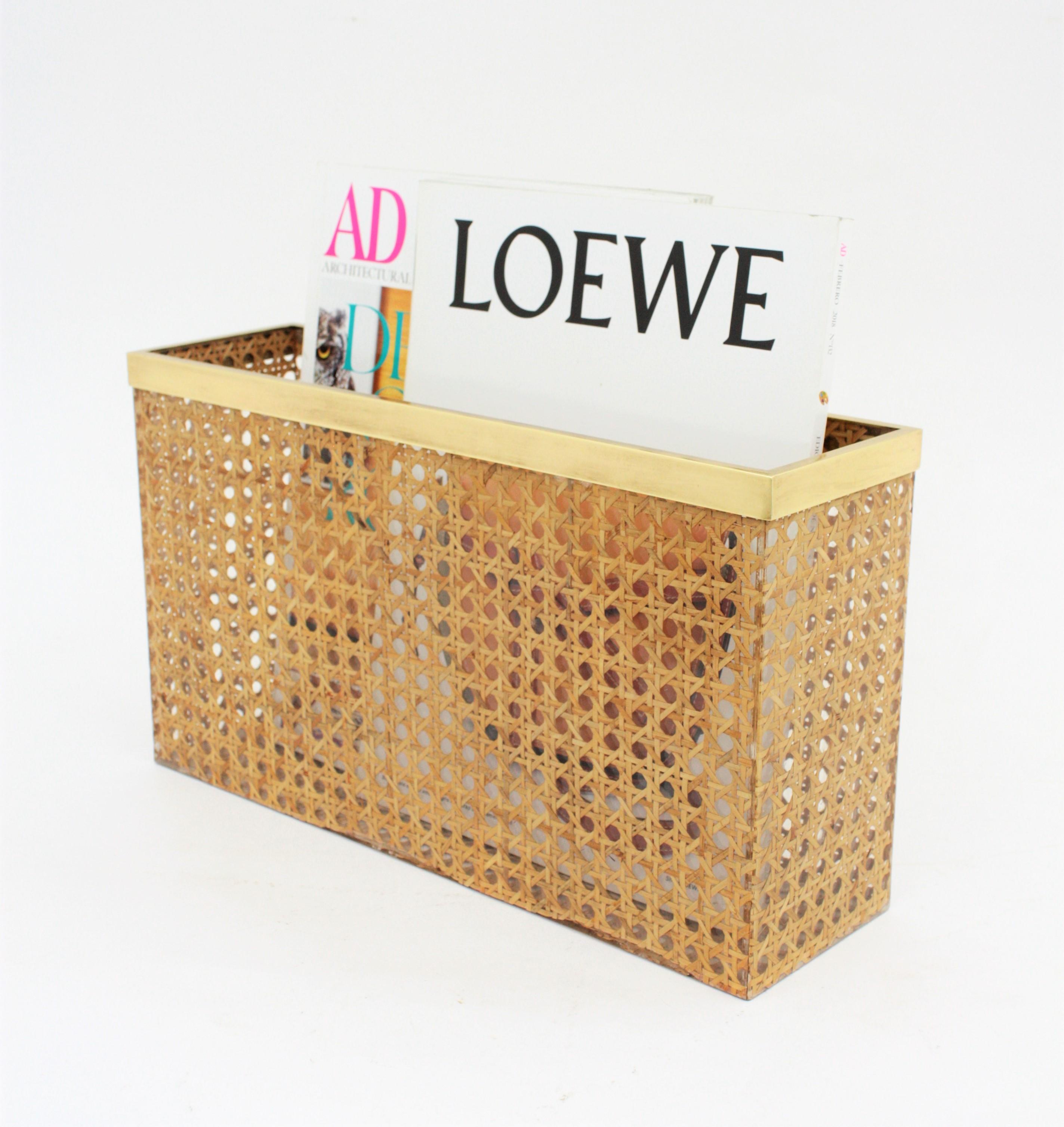 Italian 1970s Dior Home resin over wicker magazine stand with brass accents in the style of Gabriella Crespi.
This stylish Mid-Century Modern magazine rack holder is comprised of Lucite sheets with embedded woven rattan / wicker / cane work with a