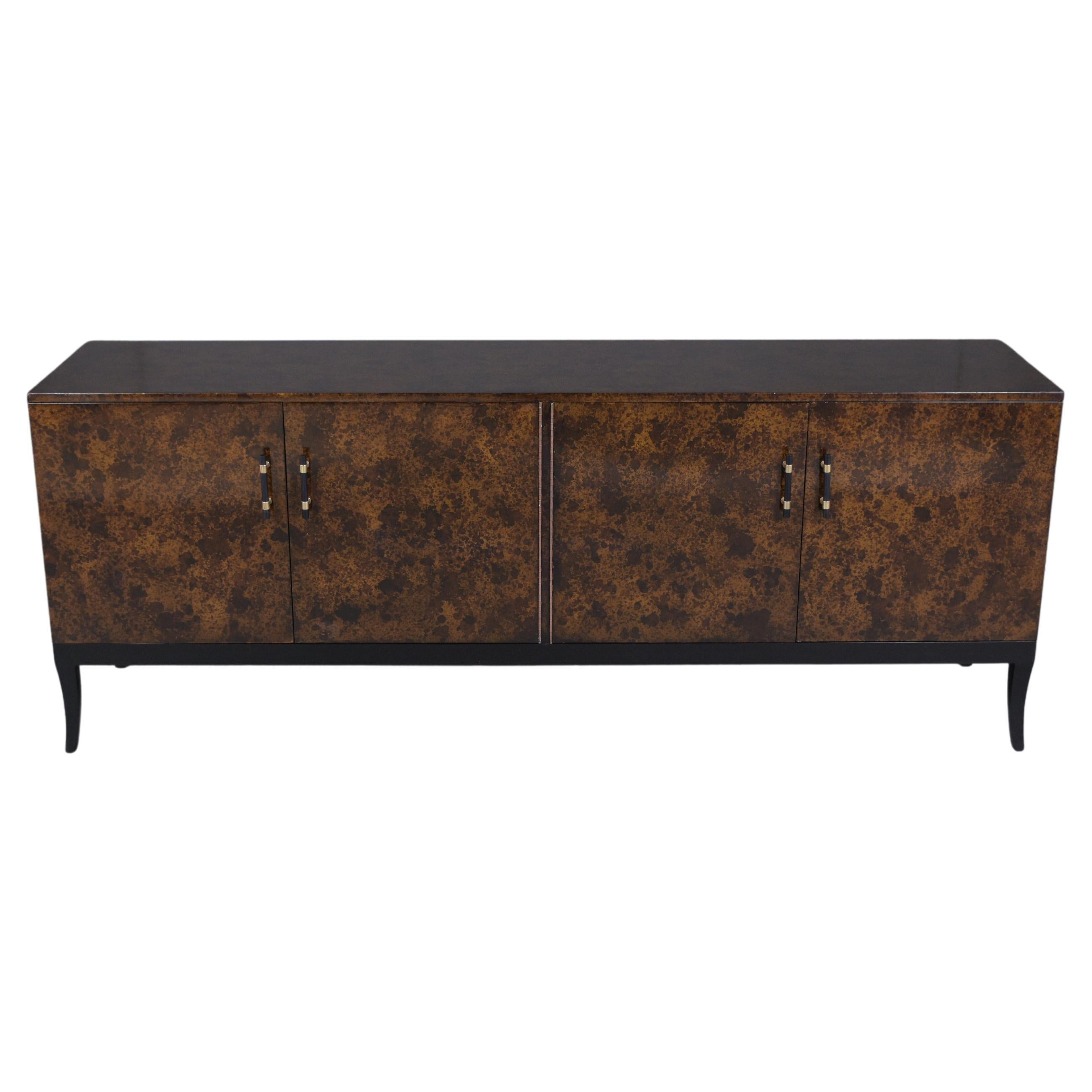 An extraordinary mid-century modern credenza beautifully crafted out of solid wood and has been newly restored by our craftsmen team. This vintage 1960s sideboard features a unique lacquered hand-made faux brown color turtle design finish, four