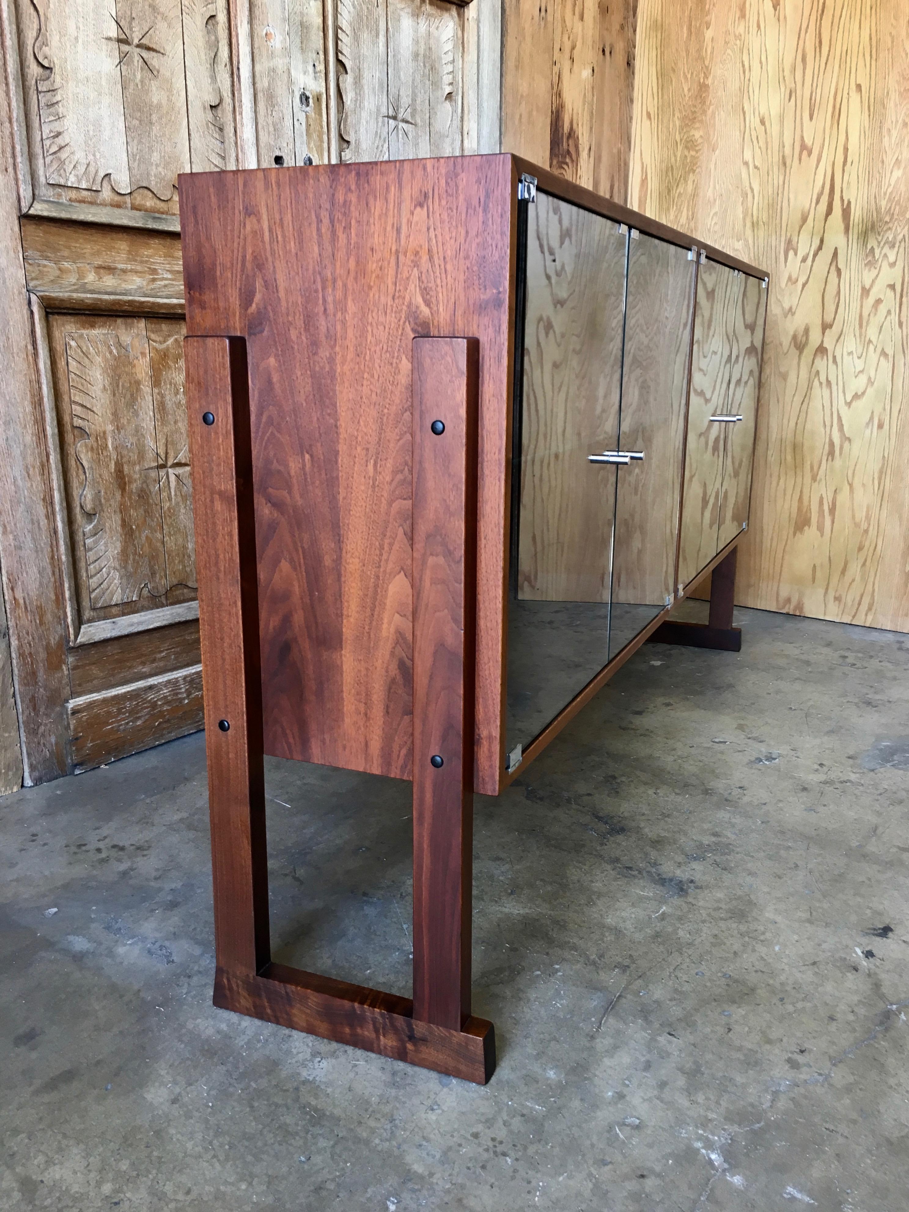 Glass front cabinet that can be used as a bookcase or china cabinet made of walnut.