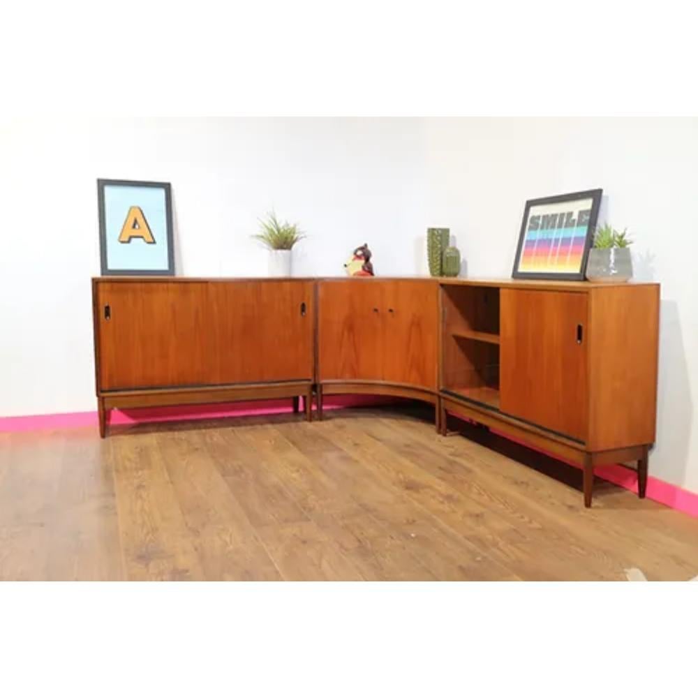 Add a touch of timeless elegance to your home decor with these Mid Century Modern Vintage Teak Danish Style Cabinets by Greaves and Thomas. Crafted in the 1960s, these beautiful pieces showcases the exquisite craftsmanship of the renowned British